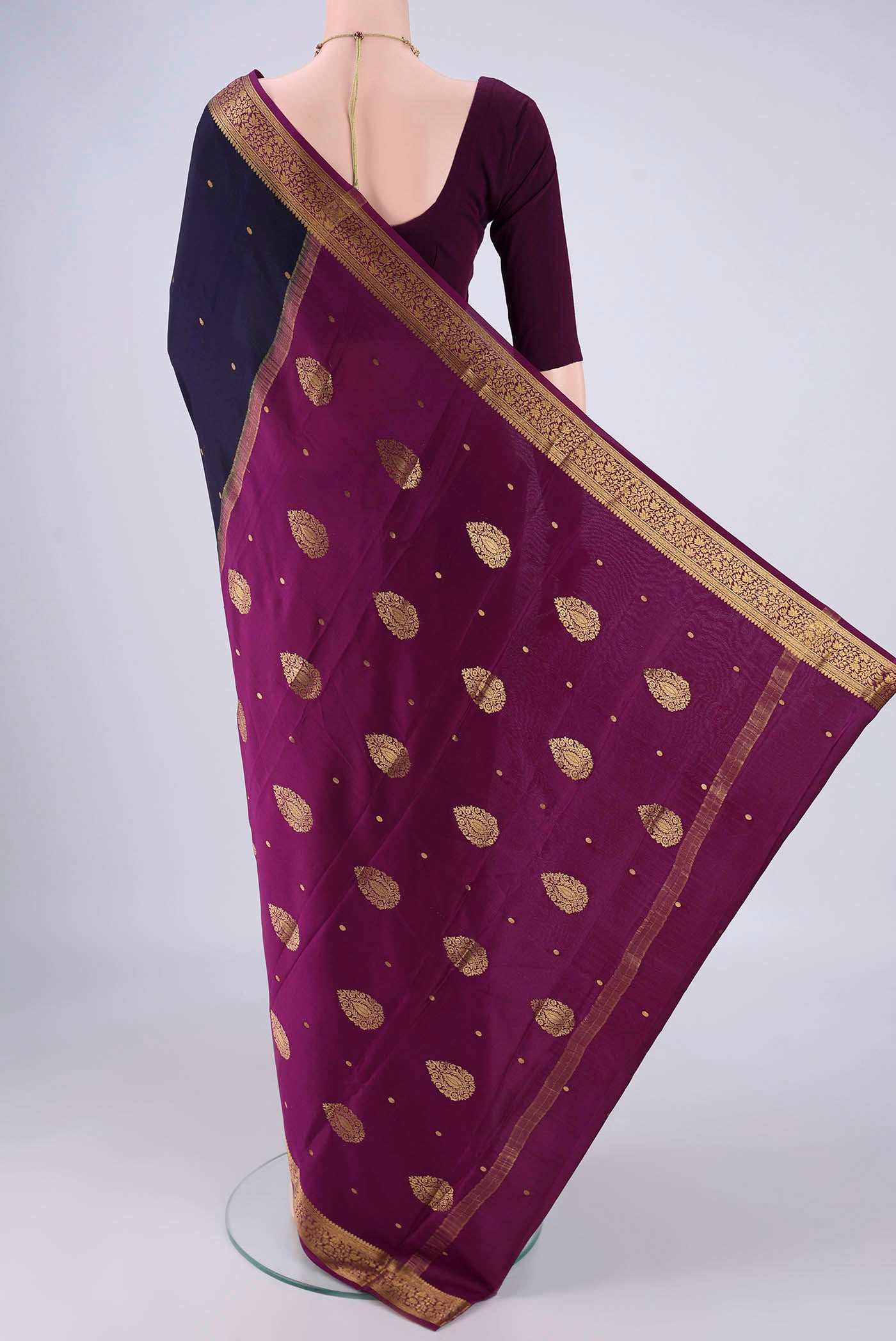 Flat view of Navy Blue Mysore Crepe Saree with Zari Butta on the body and Zari Border. 