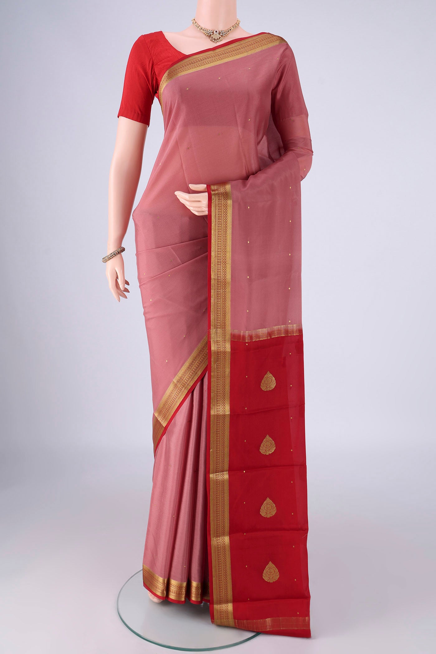 Coral Mysore Crepe Saree with Zari Butta on the body and Zari Border.  displayed on a mannequin
