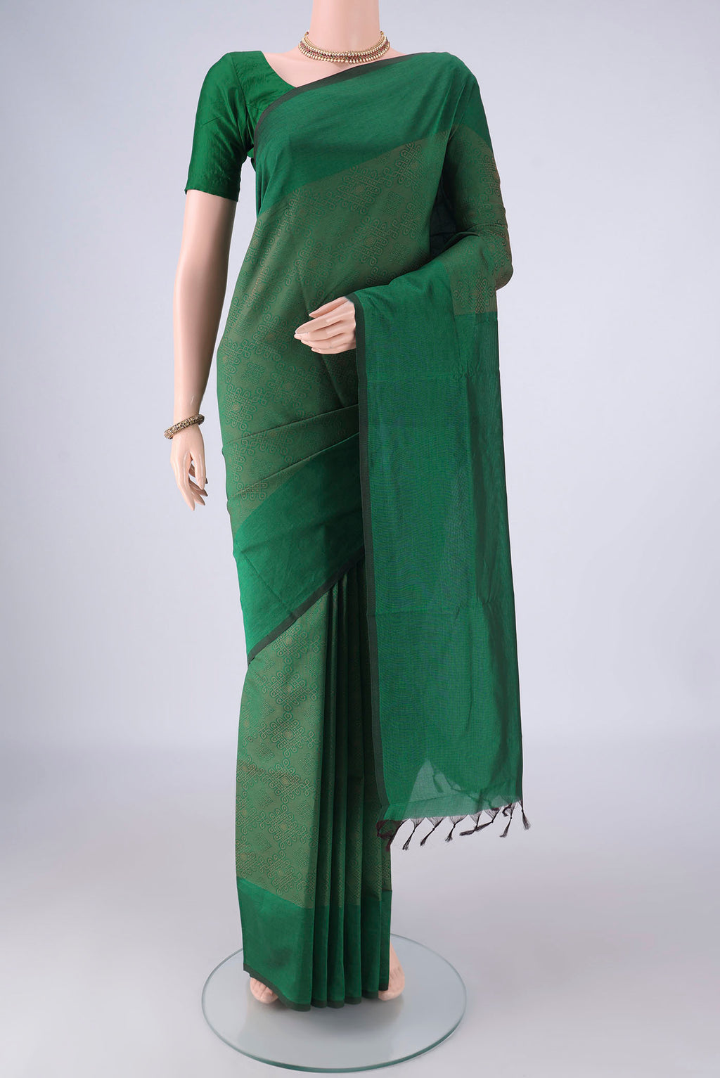 Bottle Green Blended Poly Cotton Saree with Jacquard design on the body and Plain Border.  displayed on a mannequin