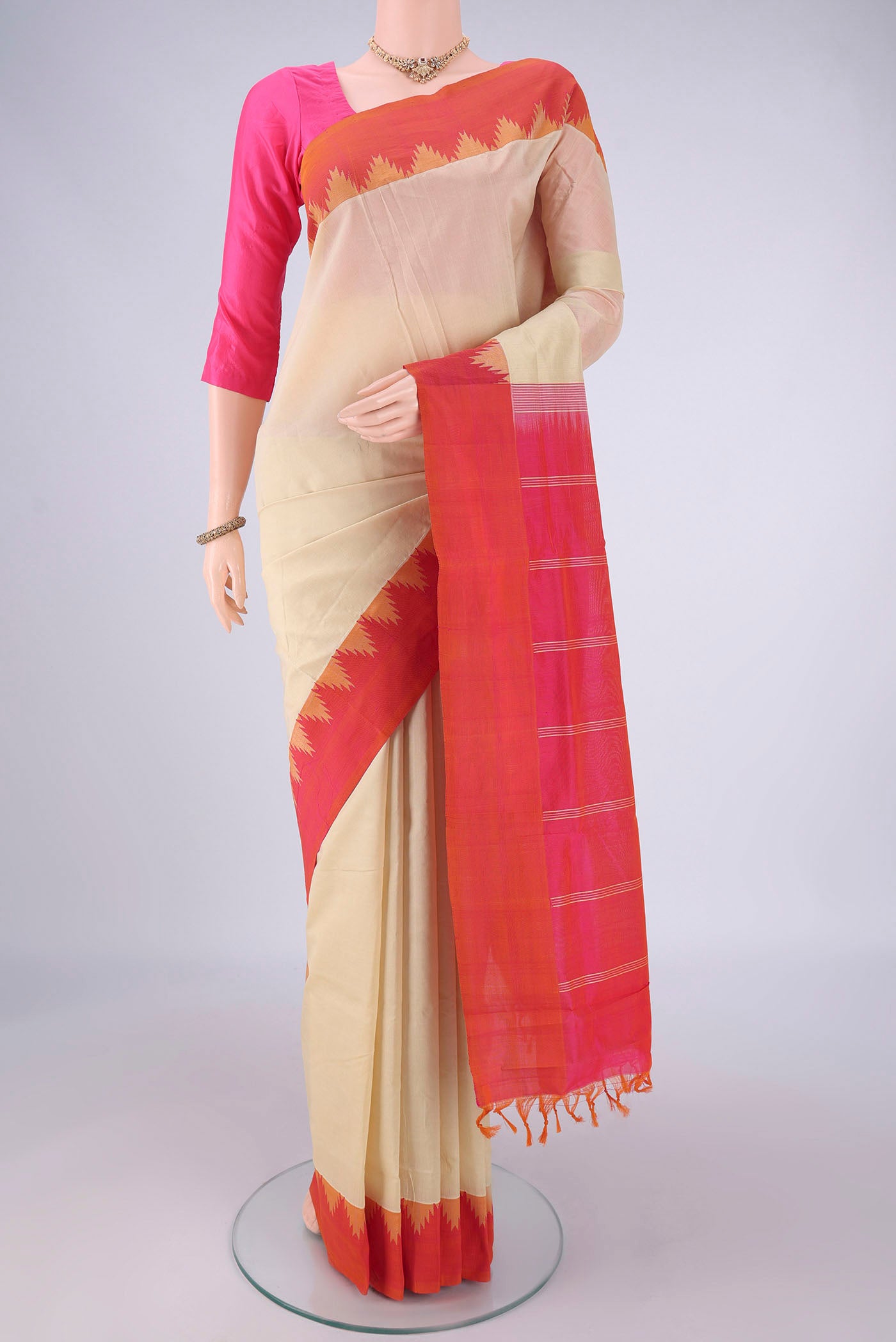 Cream Coimbatore Silk Cotton Saree with Plain Body and Temple Border.  displayed on a mannequin