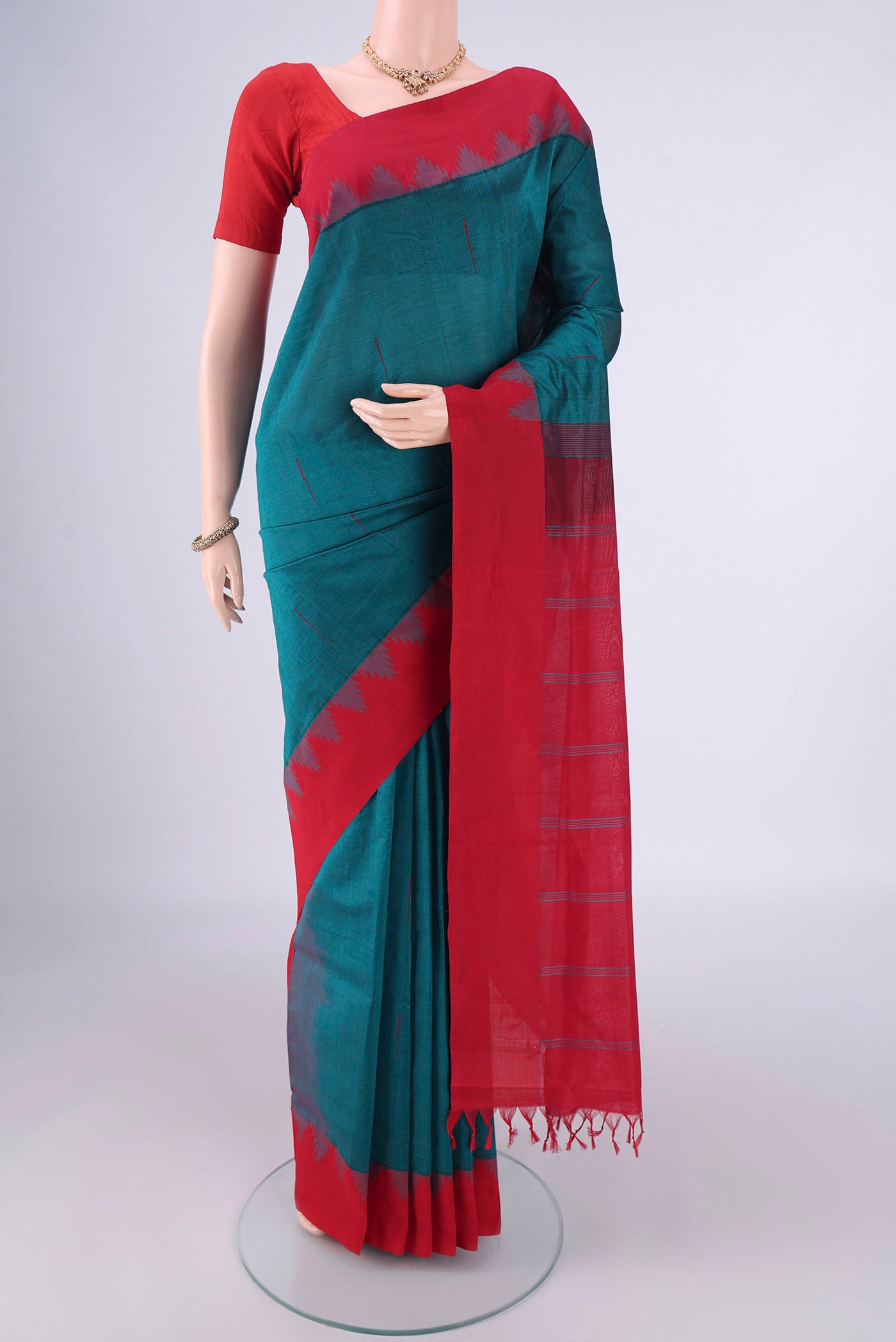 Teal Blended Poly Cotton Saree with Thread Butta on the body and Temple Border.  displayed on a mannequin