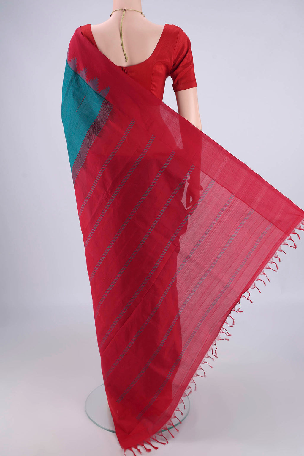 Flat view of Teal Blended Poly Cotton Saree with Thread Butta on the body and Temple Border. 