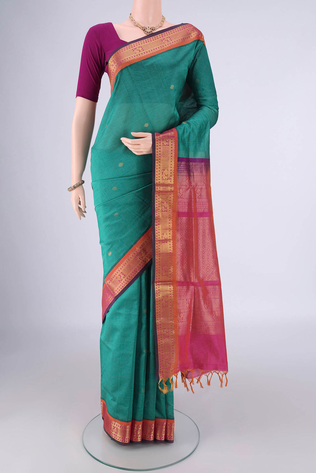 Sea Green Silk Cotton Saree with Zari Butta on the body and Zari Border.  displayed on a mannequin