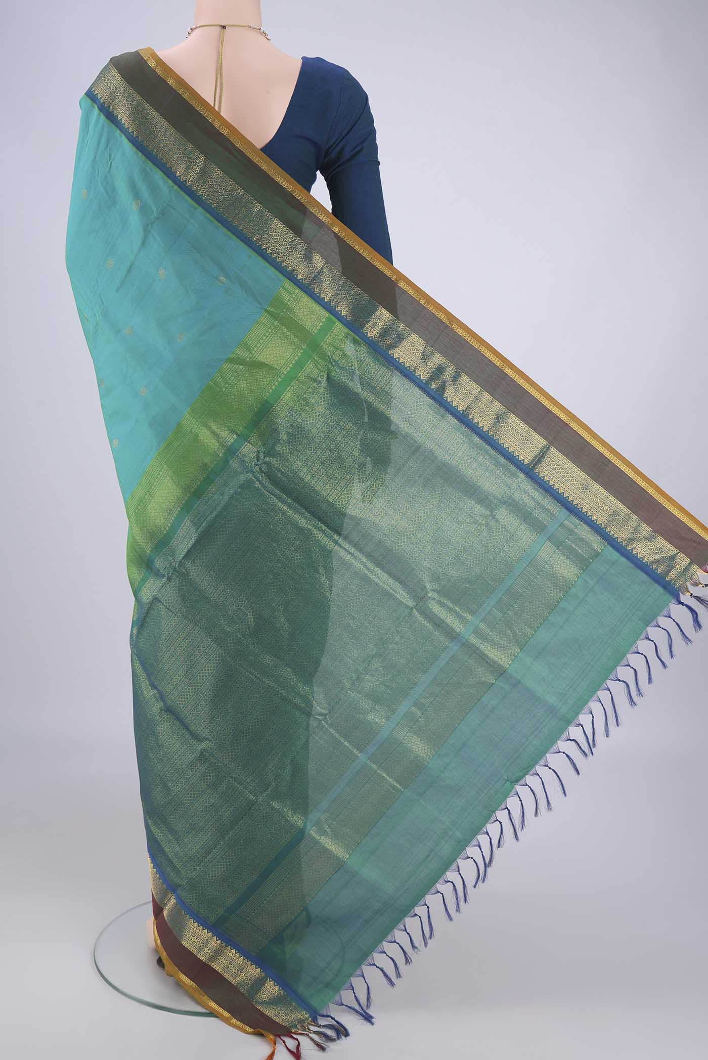 Flat view of Sea Green Coimbatore Silk Cotton Saree with Zari Butta on the body and Zari Border. 
