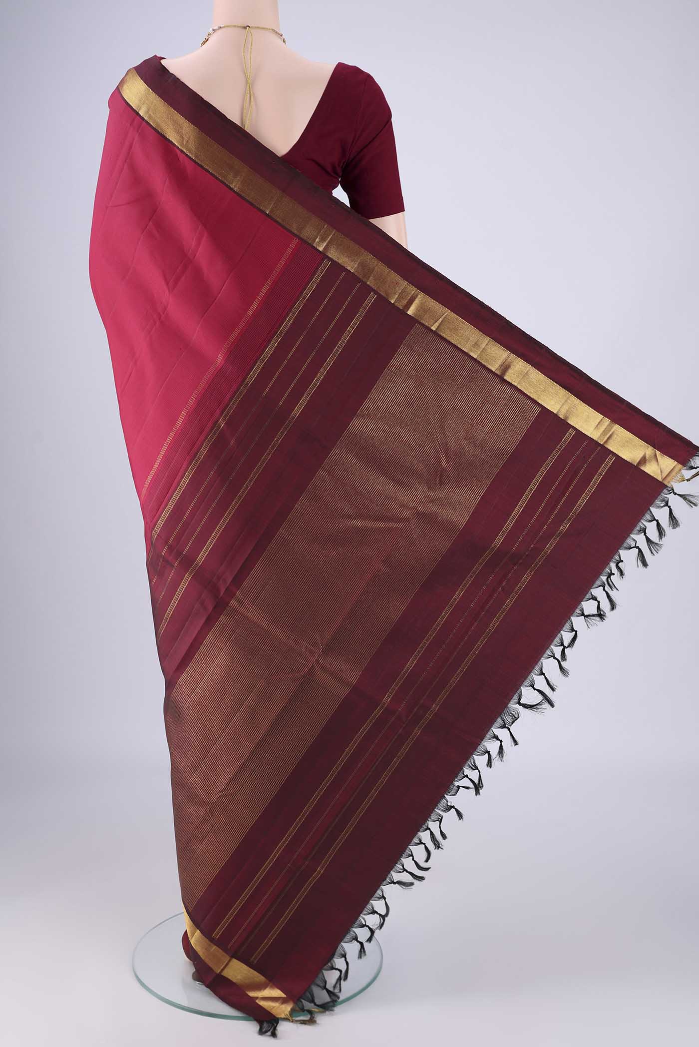 Flat view of Coral Kanjivaram Silk Saree with Plain Body and Zari Border. 