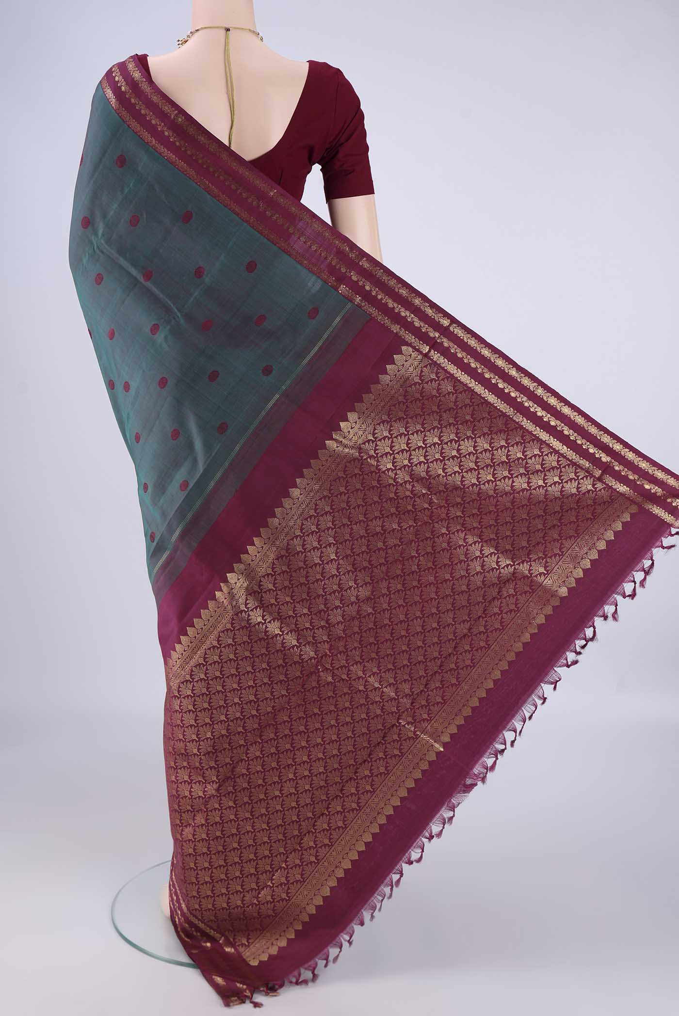 Flat view of Peacock Blue Dual Tone Kanjivaram Silk Saree with Thread Butta on the body and Zari Border. 