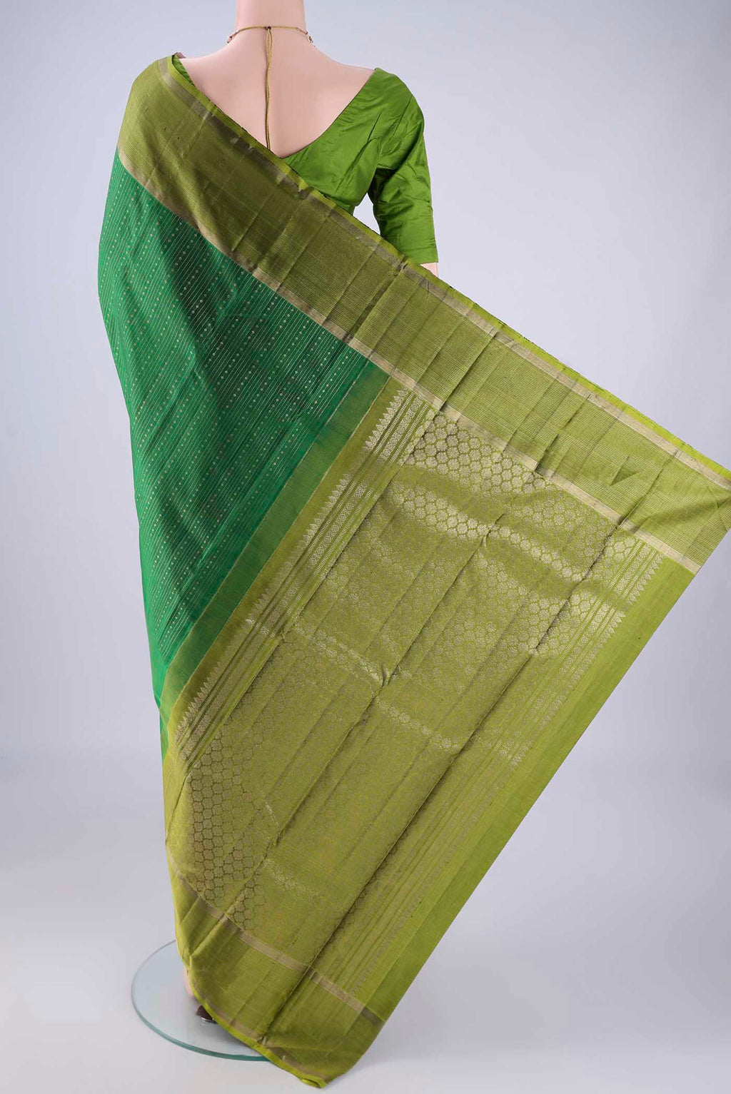 Flat view of Bottle Green Kanchipuram Silk Saree with Stripes on the body and Zari Border. 