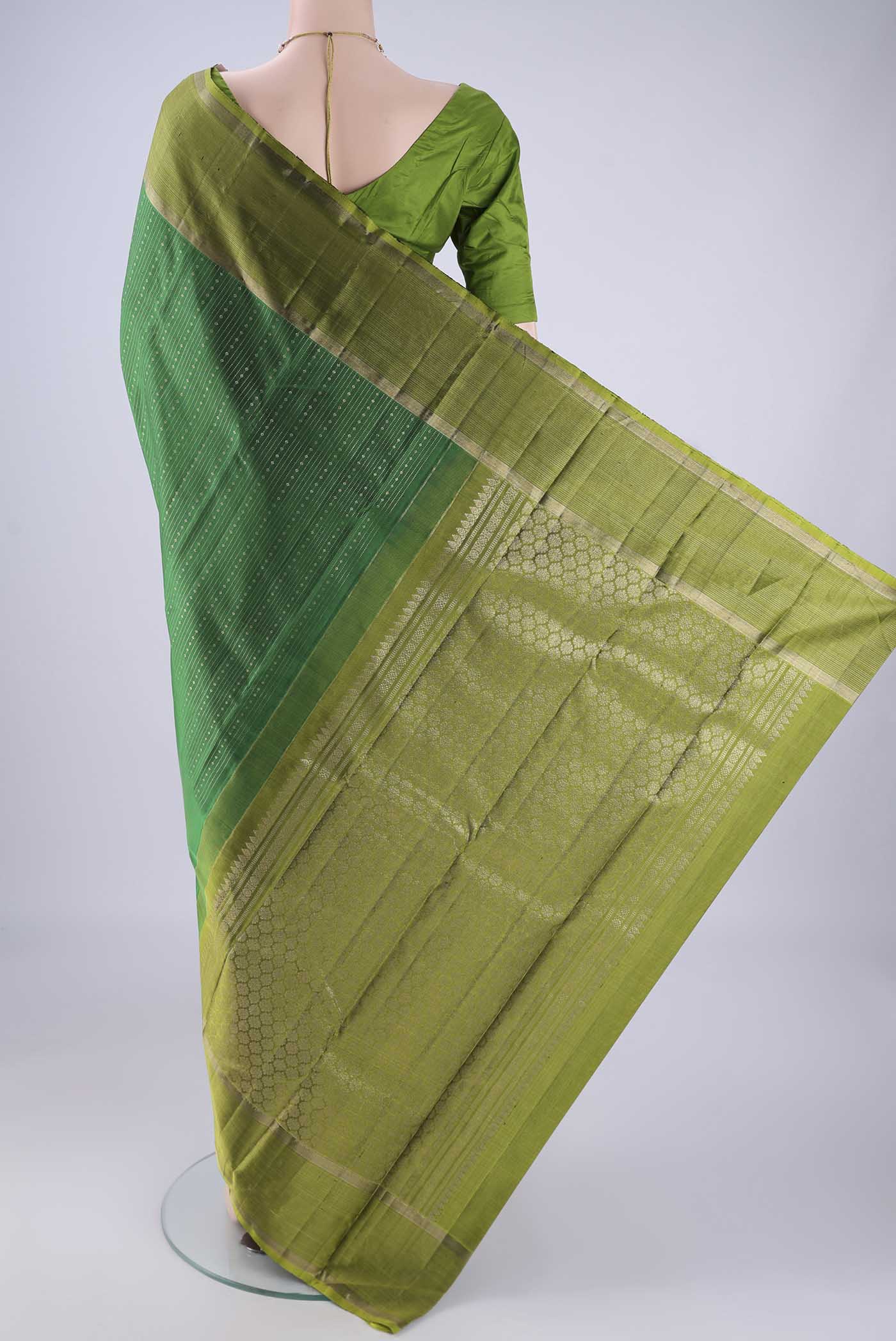 Flat view of Bottle Green Kanchipuram Silk Saree with Stripes on the body and Zari Border. 