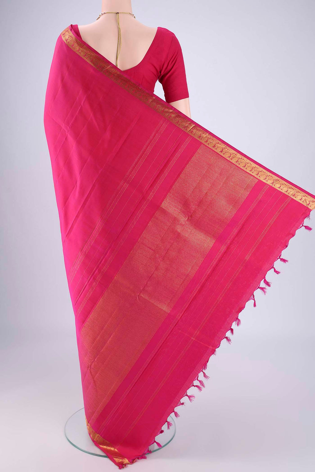 Flat view of Rani Pink Kanjivaram Silk Saree with Plain Body and Zari Border. 
