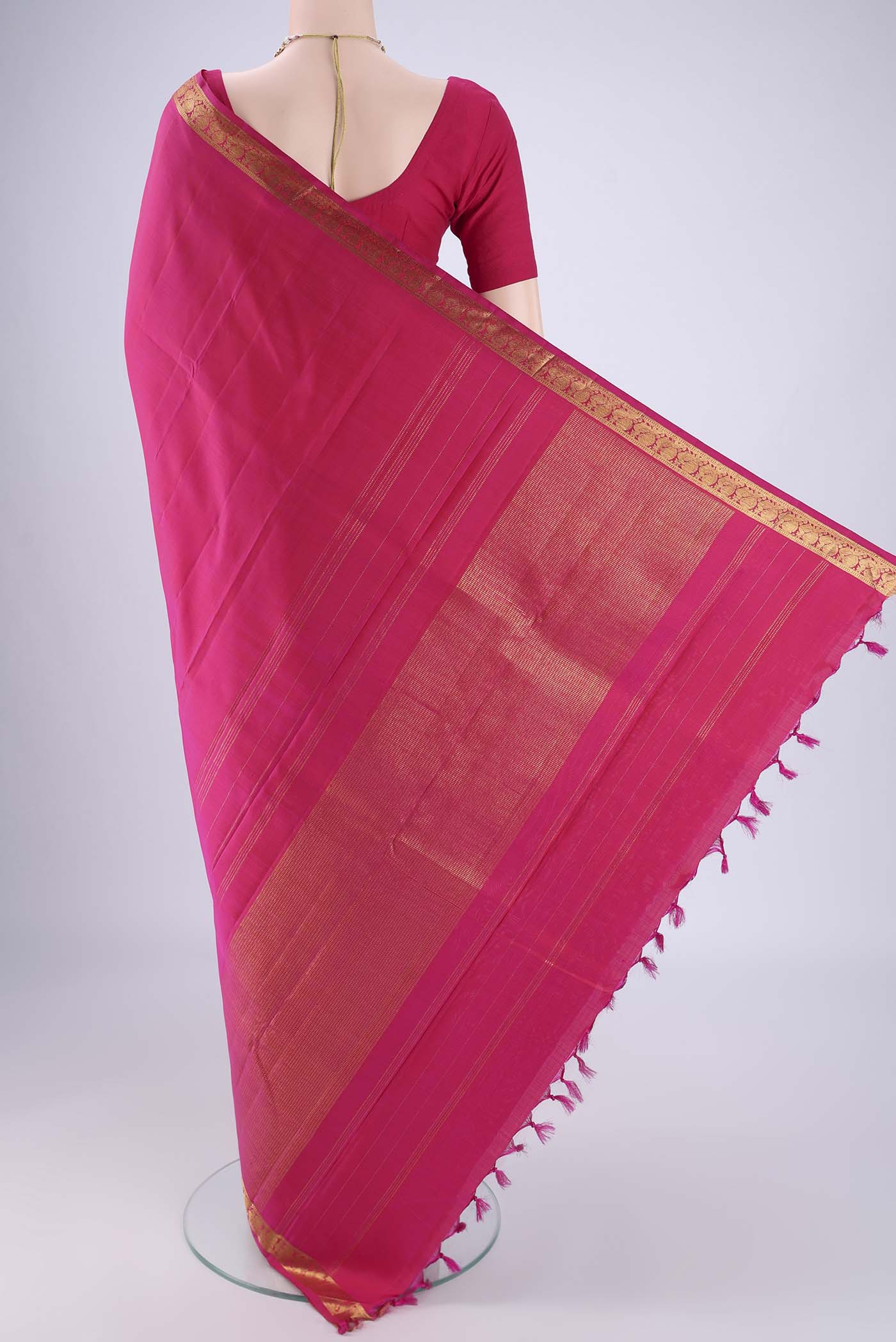 Flat view of Rani Pink Kanjivaram Silk Saree with Plain Body and Zari Border. 