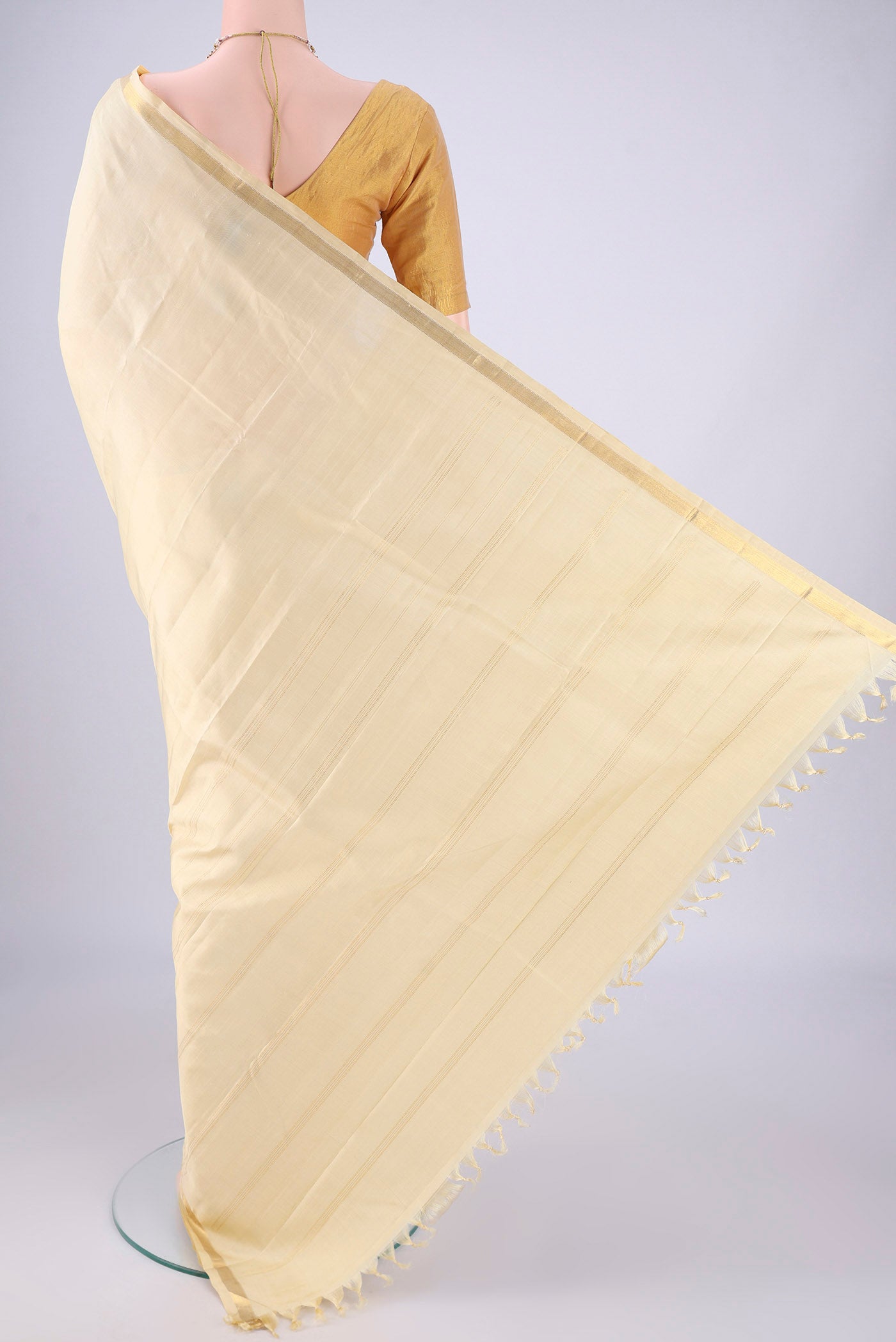 Flat view of Cream Kanjivaram Silk Saree with Plain Body and Zari Border. 