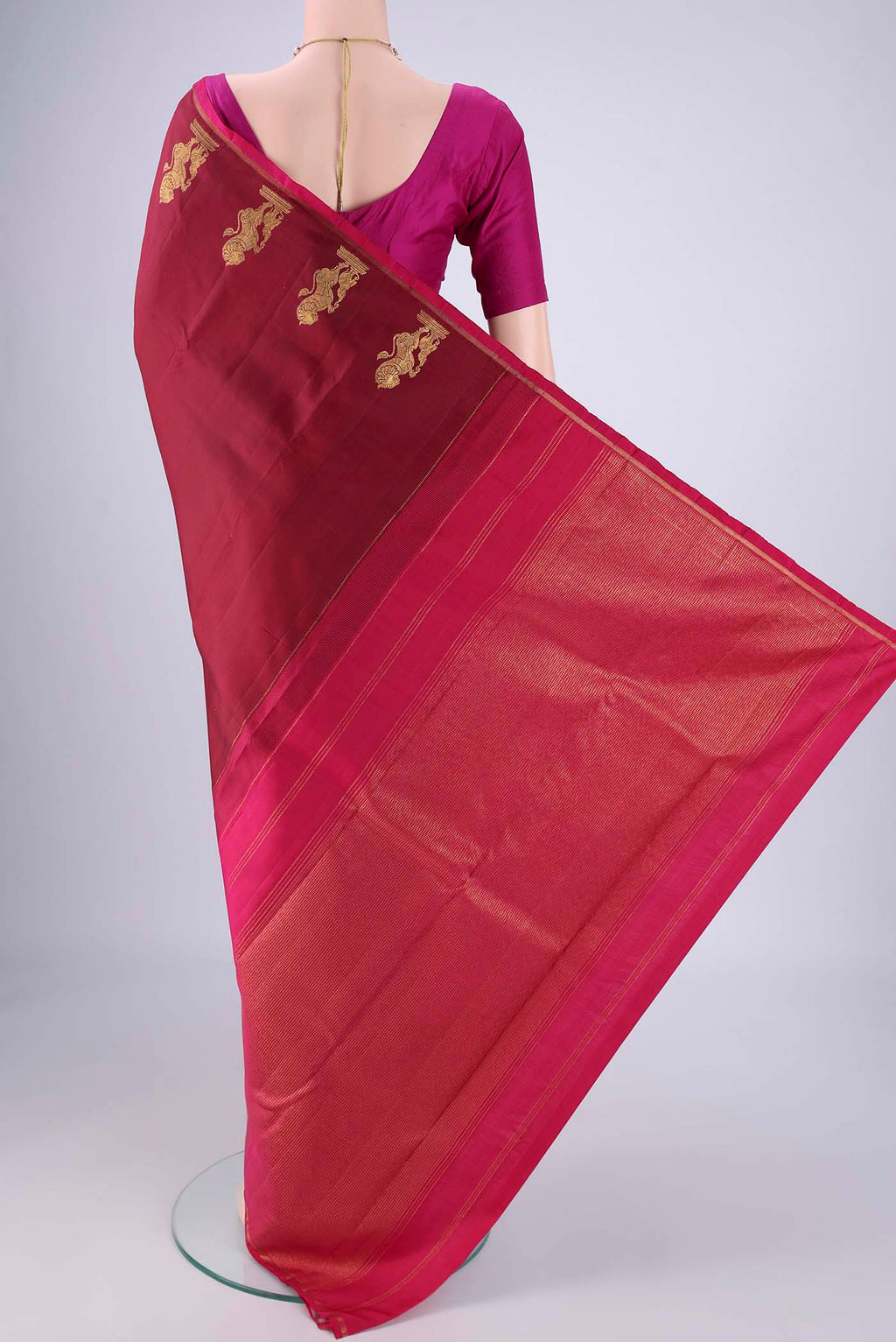 Flat view of Maroon Kanchipuram Silk Saree with Plain Body and Zari Border. 