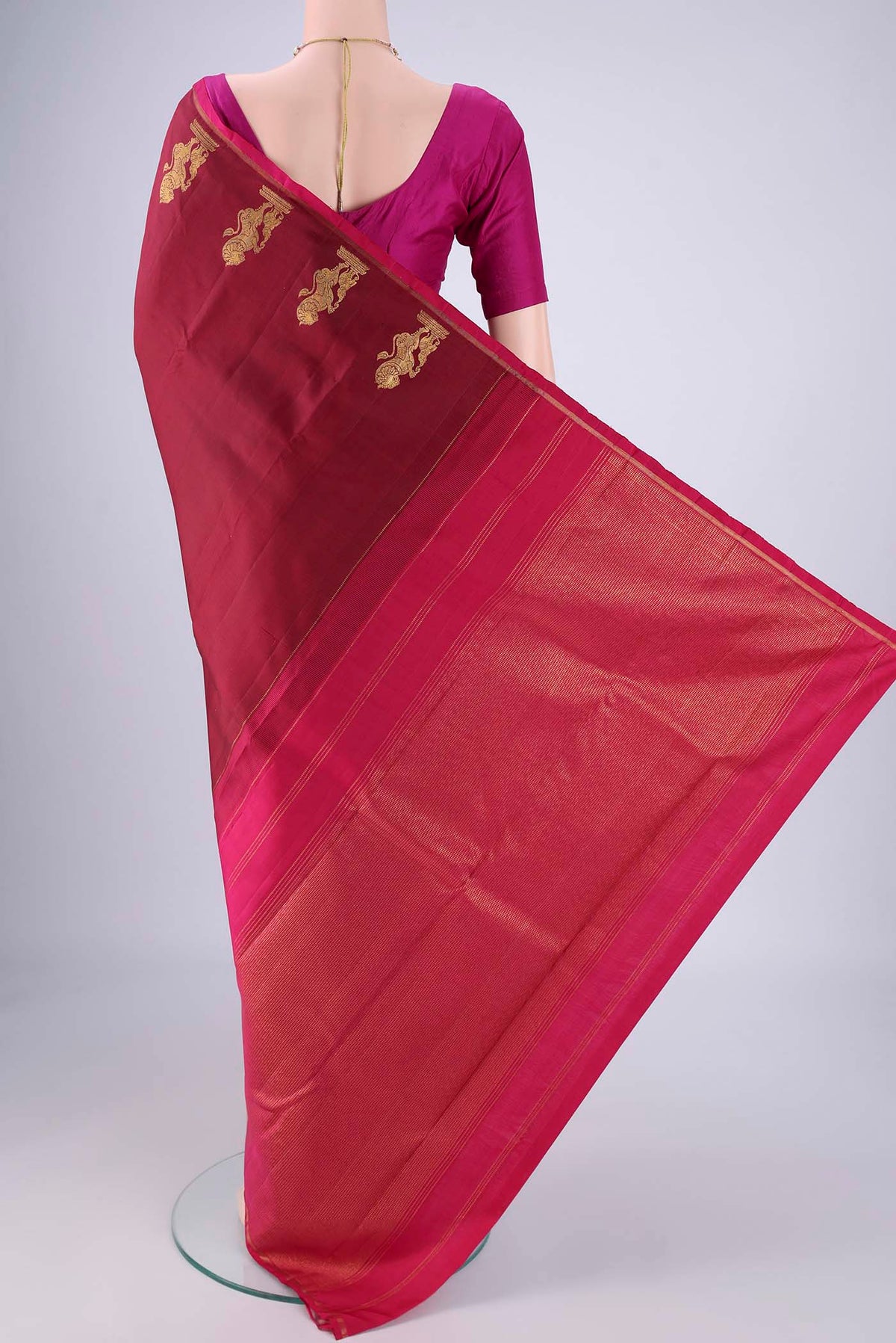 Flat view of Maroon Kanchipuram Silk Saree with Plain Body and Zari Border. 