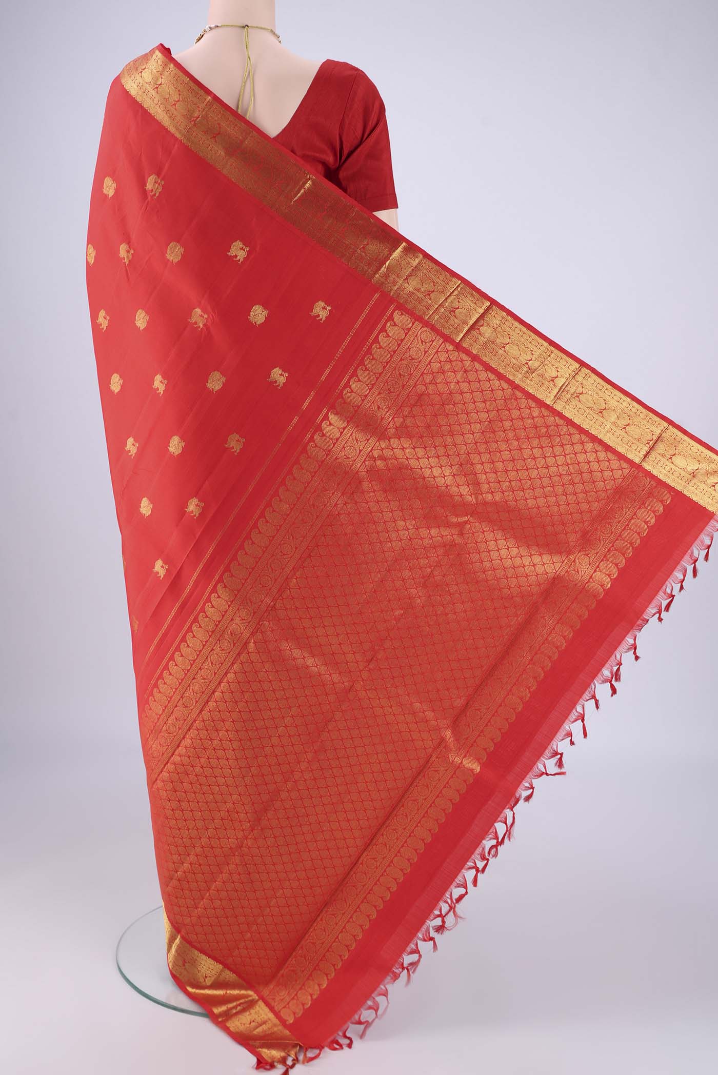 Flat view of Red Kanjivaram Silk Saree with Zari Butta on the body and Zari Border. 