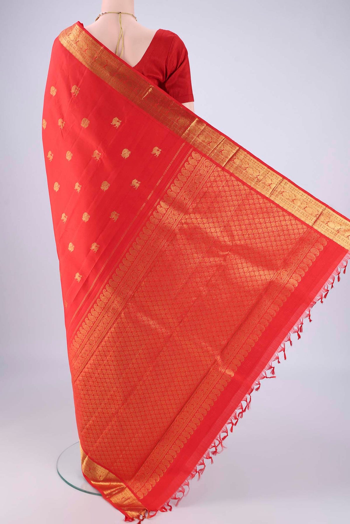 Flat view of Red Kanjivaram Silk Saree with Zari Butta on the body and Zari Border. 
