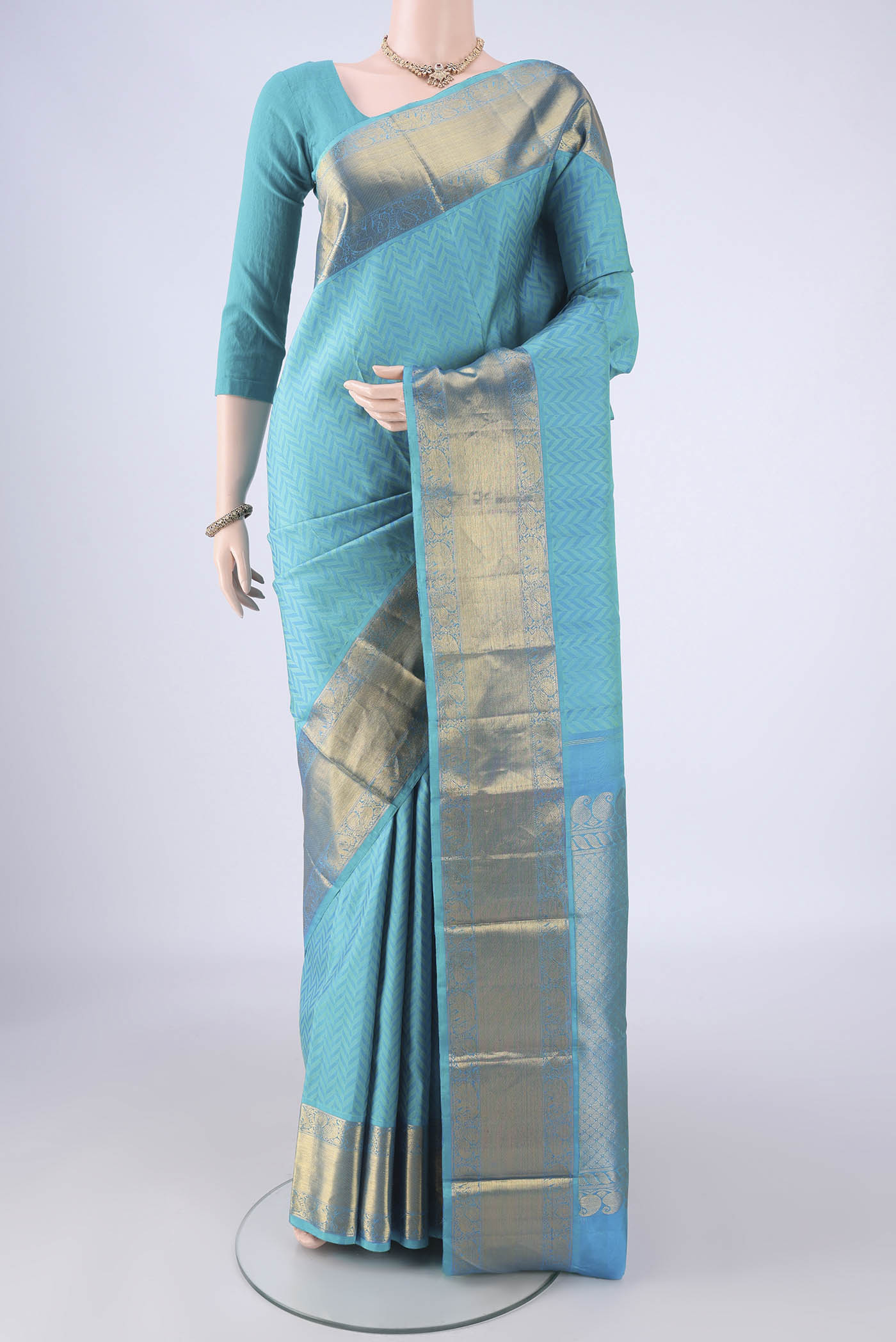 Sky Blue Kanjivaram Silk Saree with Jacquard design on the body and Zari Border.  displayed on a mannequin