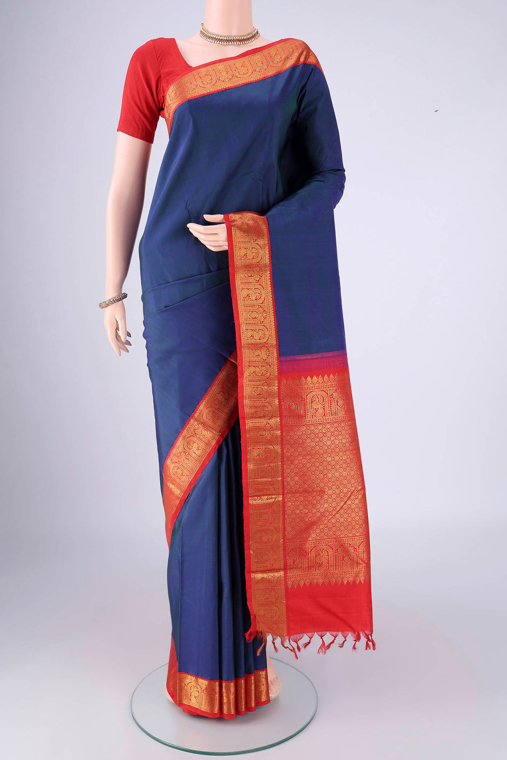 Dark Blue Kanjivaram Silk Saree with Plain Body and Zari Border.  displayed on a mannequin