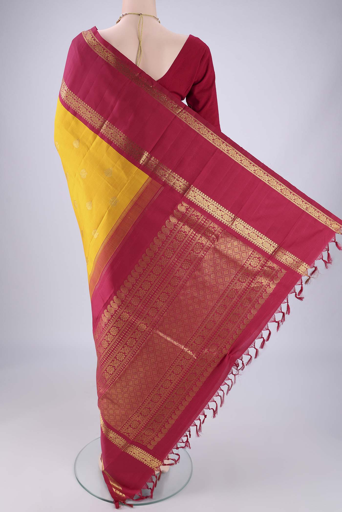 Flat view of Yellow Kanjivaram Silk Saree with Zari Butta on the body and Zari Border. 
