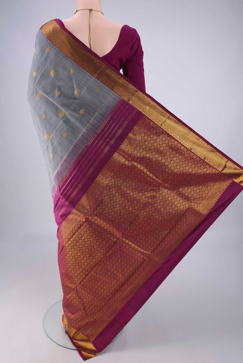 Flat view of Grey Kanchipuram Silk Saree with Zari Butta on the body and Zari Border. 