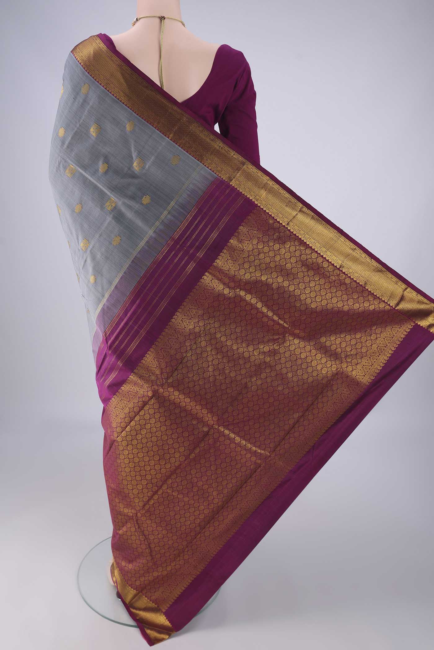 Flat view of Grey Kanchipuram Silk Saree with Zari Butta on the body and Zari Border. 