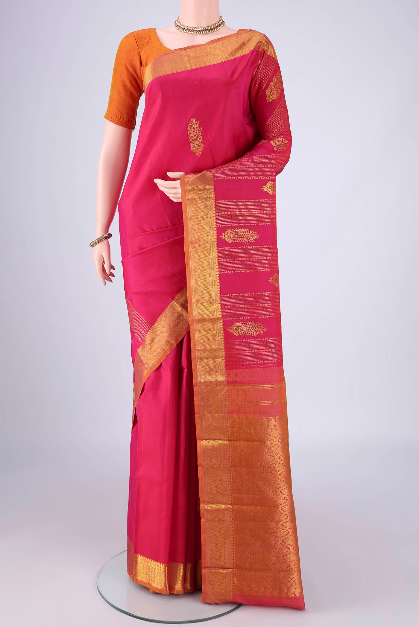 Pink Kanjivaram Silk Saree with Zari Brocade on the body and Zari Border.  displayed on a mannequin