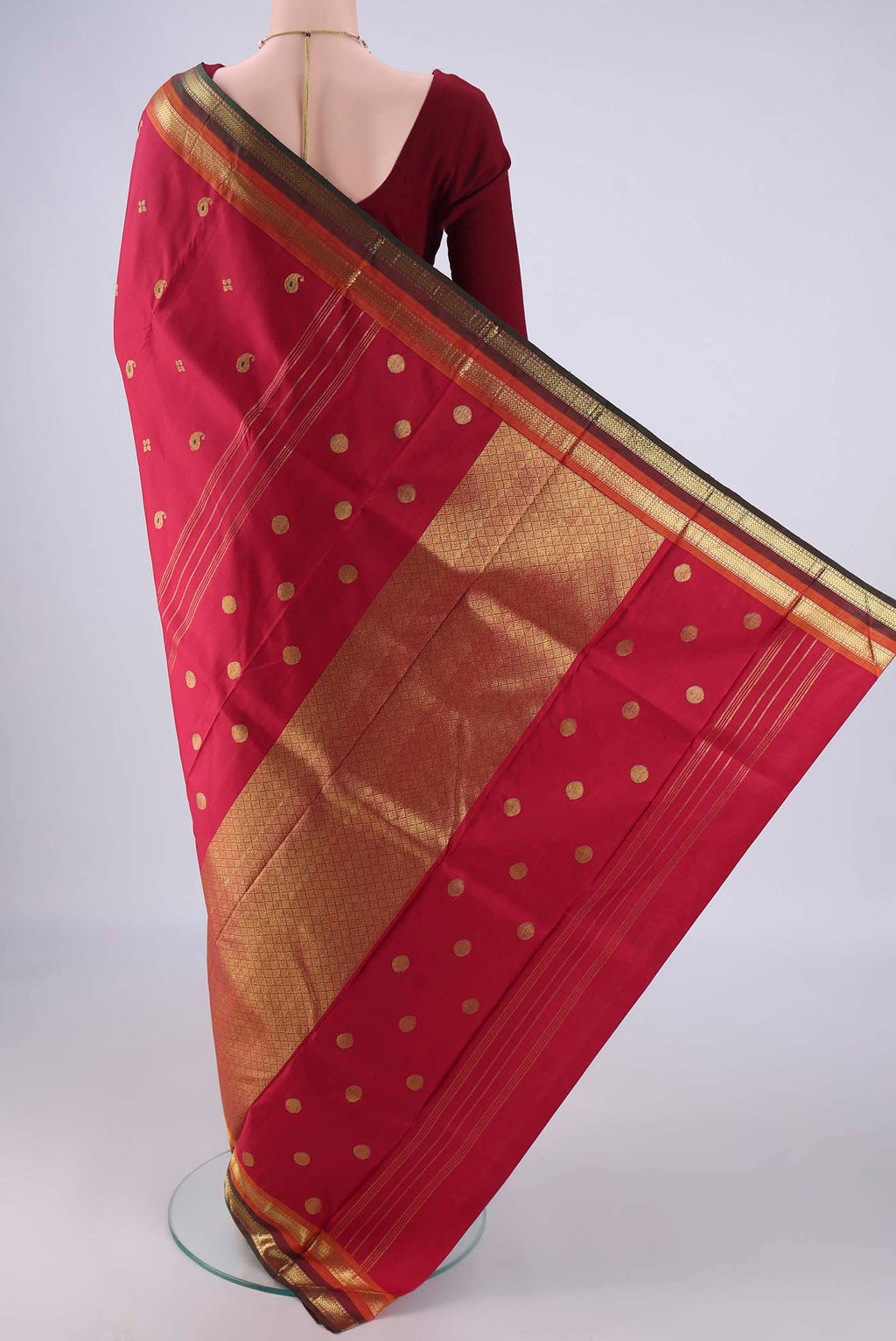 Flat view of Maroon Kanjivaram Silk Saree with Zari And Thread Butta on the body and Zari Border. 