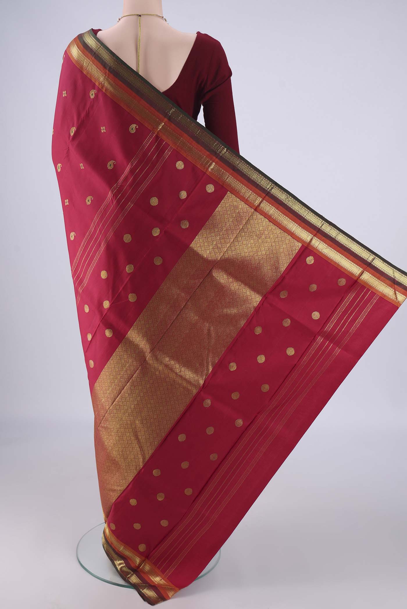 Flat view of Maroon Kanjivaram Silk Saree with Zari And Thread Butta on the body and Zari Border. 
