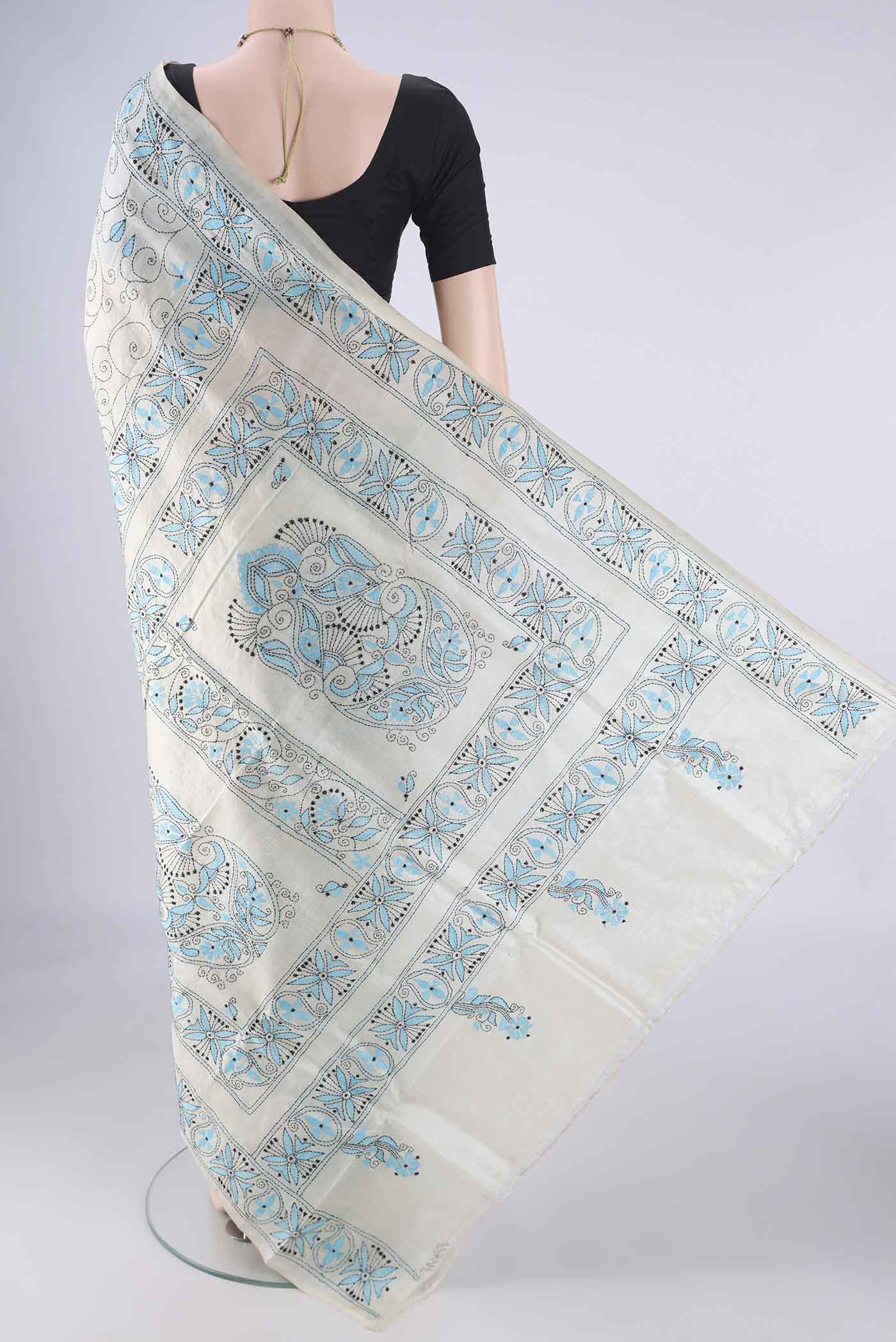 Flat view of Beige Tussar Silk Saree with Kantha Work on the body and Thread Border. 