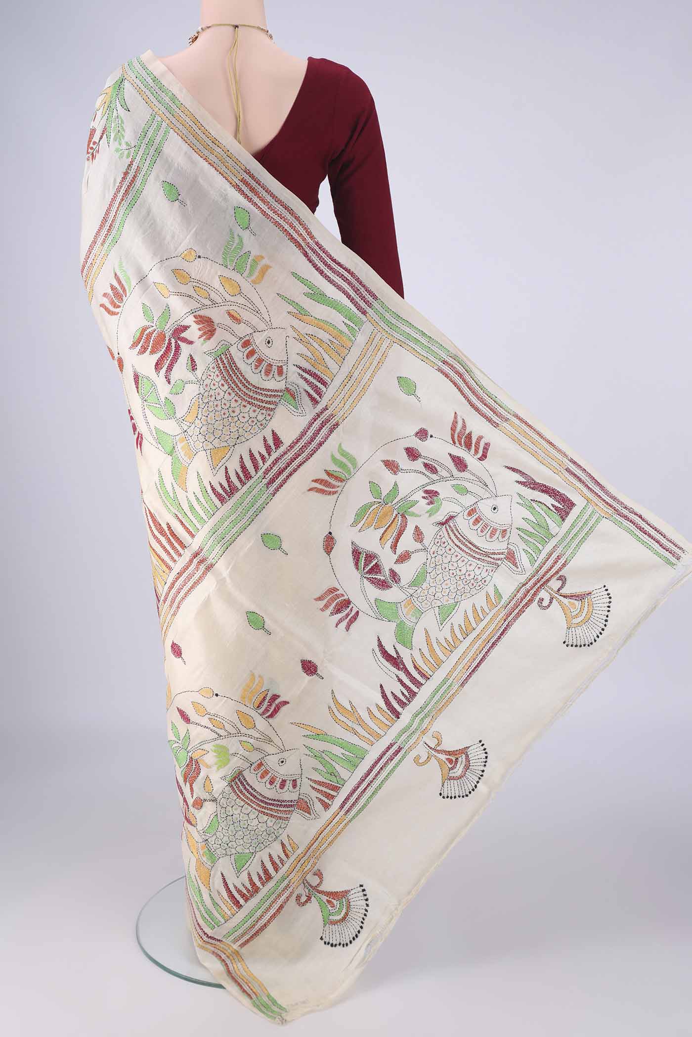 Flat view of Beige Tussar Silk Saree with Kantha Work on the body and Thread Border. 