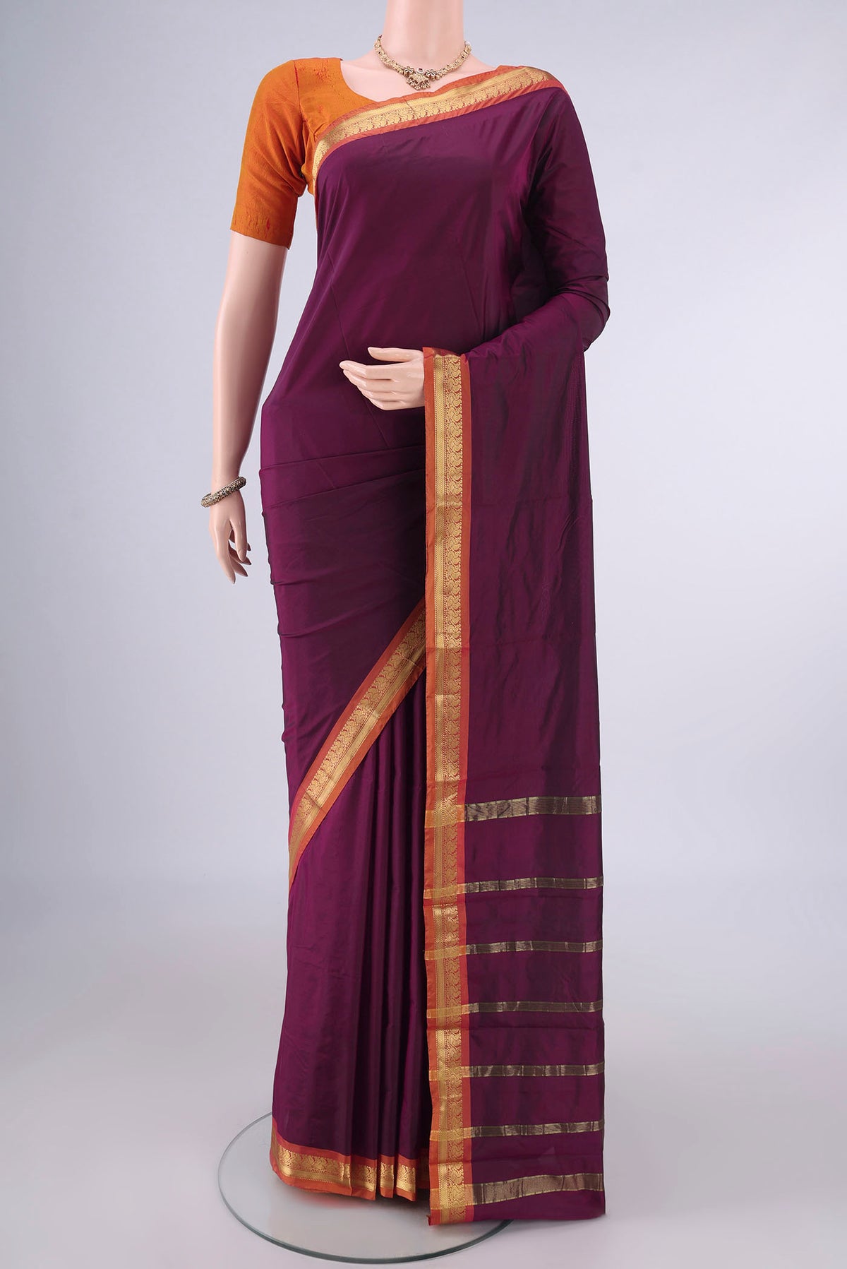 Maroon Blended Bangalore Silk Saree with Plain Body and Zari Border.  displayed on a mannequin