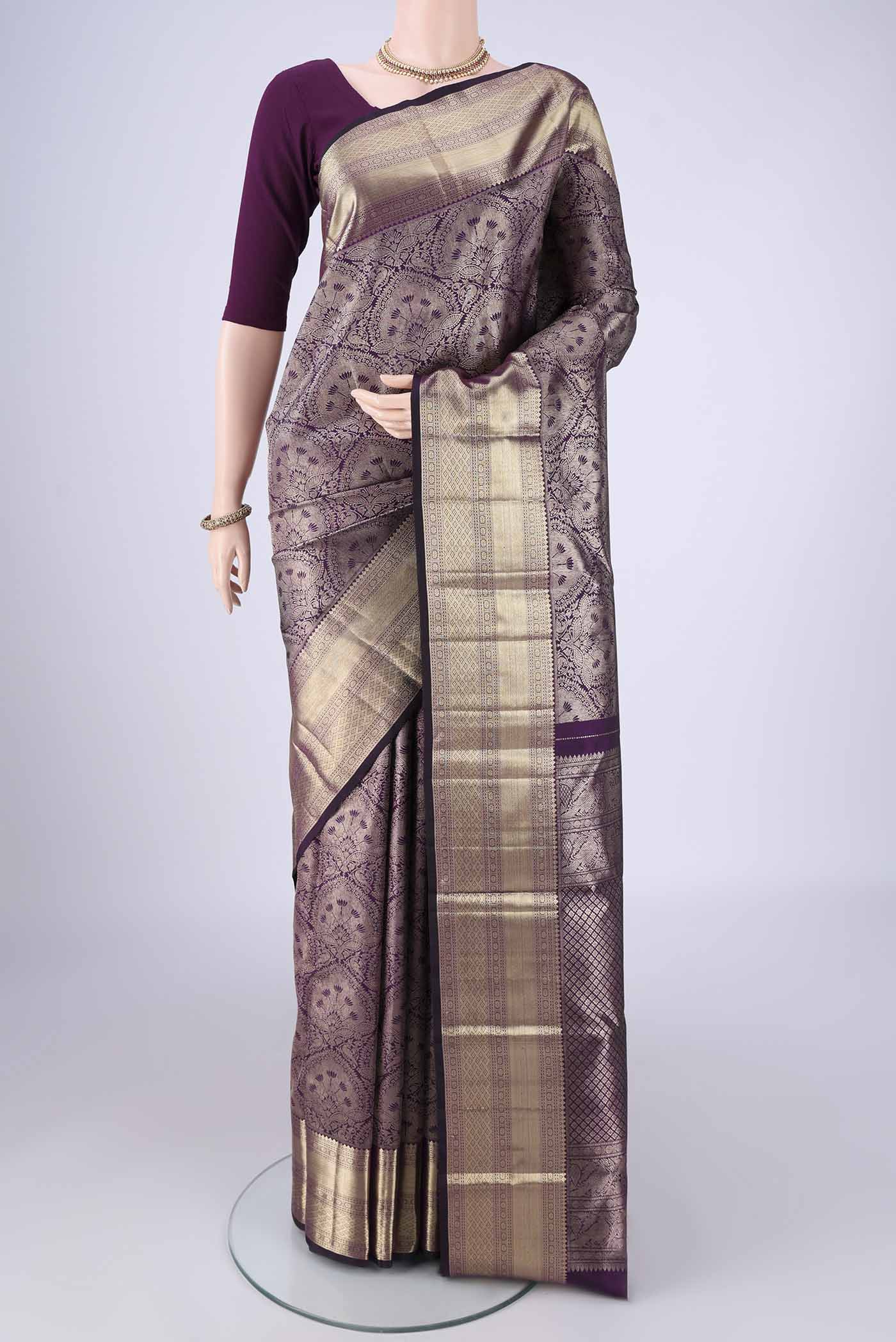 Purple Kanchipuram Silk Saree with Zari Brocade on the body and Zari Border.  displayed on a mannequin