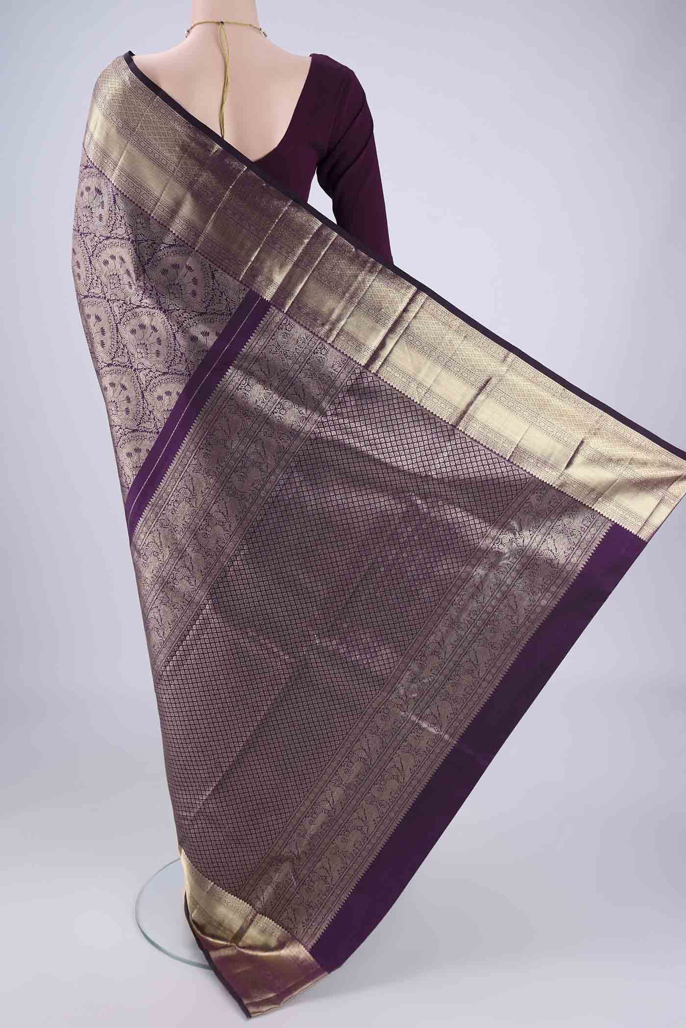 Flat view of Purple Kanchipuram Silk Saree with Zari Brocade on the body and Zari Border. 