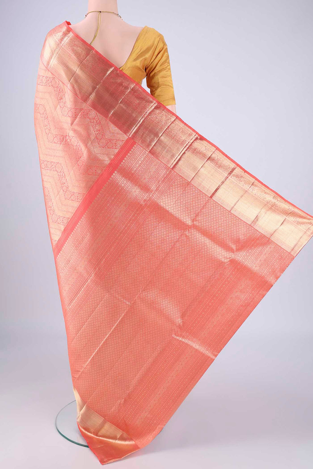 Flat view of Peach Kanchipuram Silk Saree with Zari Brocade on the body and Zari Border. 