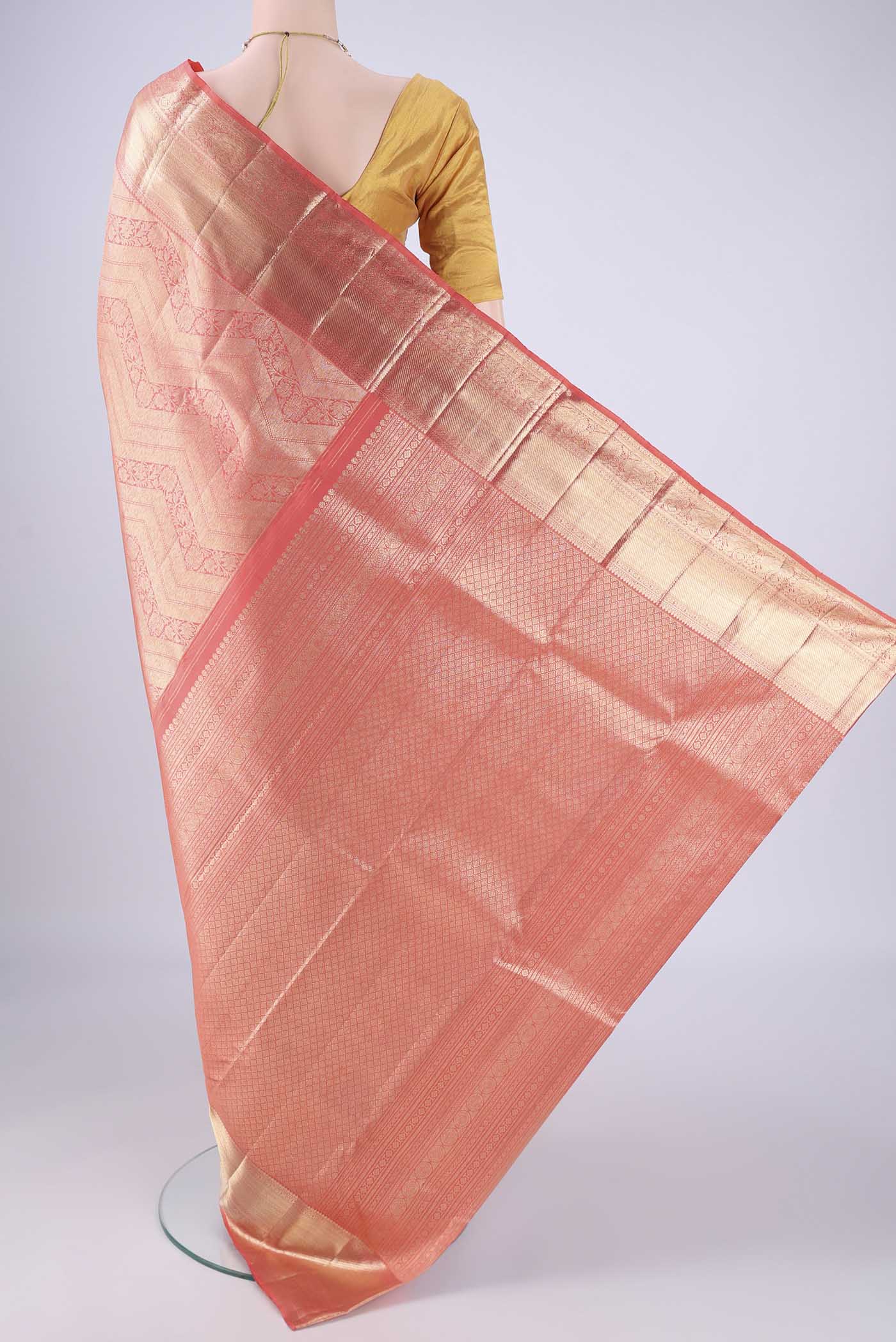 Flat view of Peach Kanchipuram Silk Saree with Zari Brocade on the body and Zari Border. 