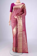 Magenta Kanchipuram Silk Saree with Zari Brocade on the body and Zari Border.  displayed on a mannequin