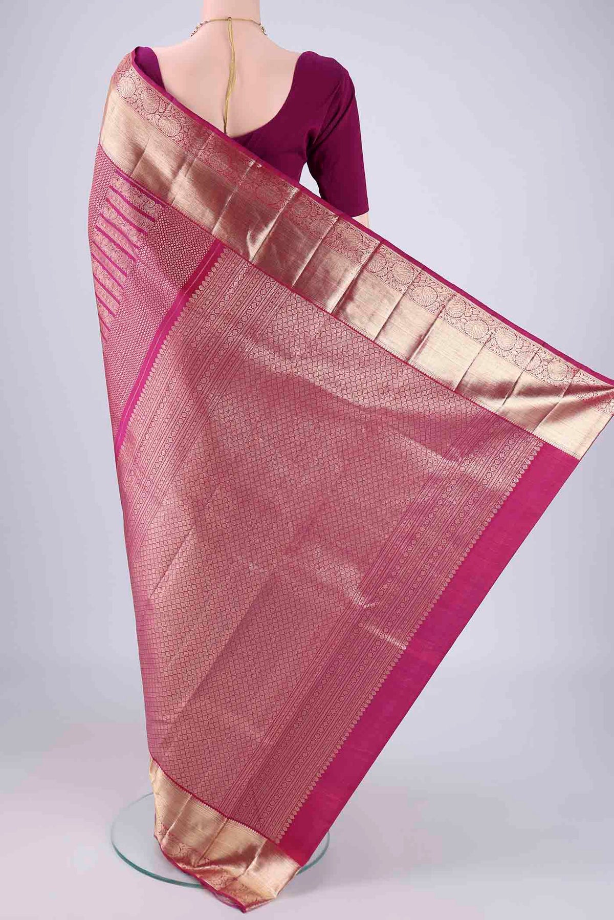 Flat view of Magenta Kanchipuram Silk Saree with Zari Brocade on the body and Zari Border. 