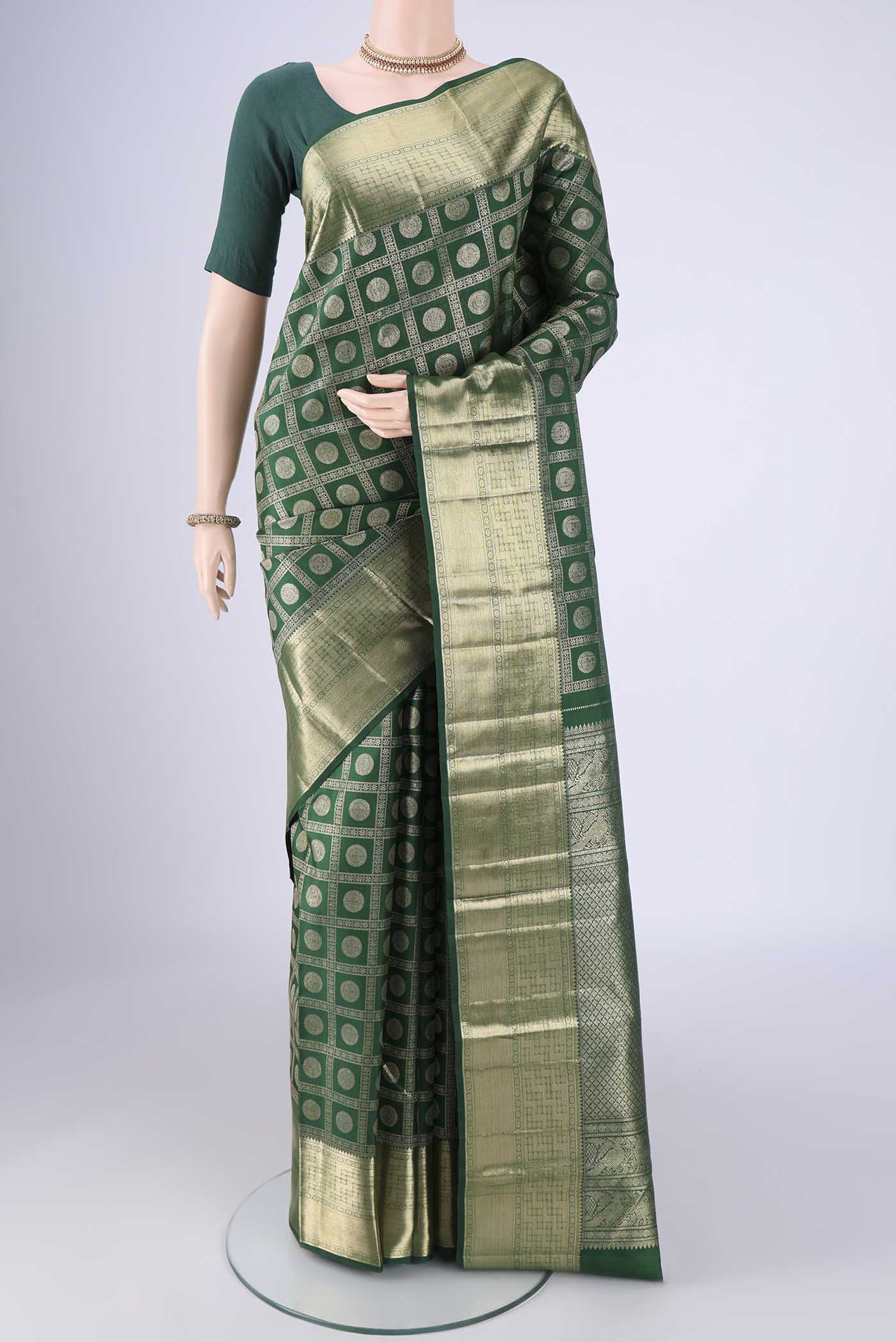 Bottle Green Kanchipuram Silk Saree with Zari Brocade on the body and Zari Border.  displayed on a mannequin