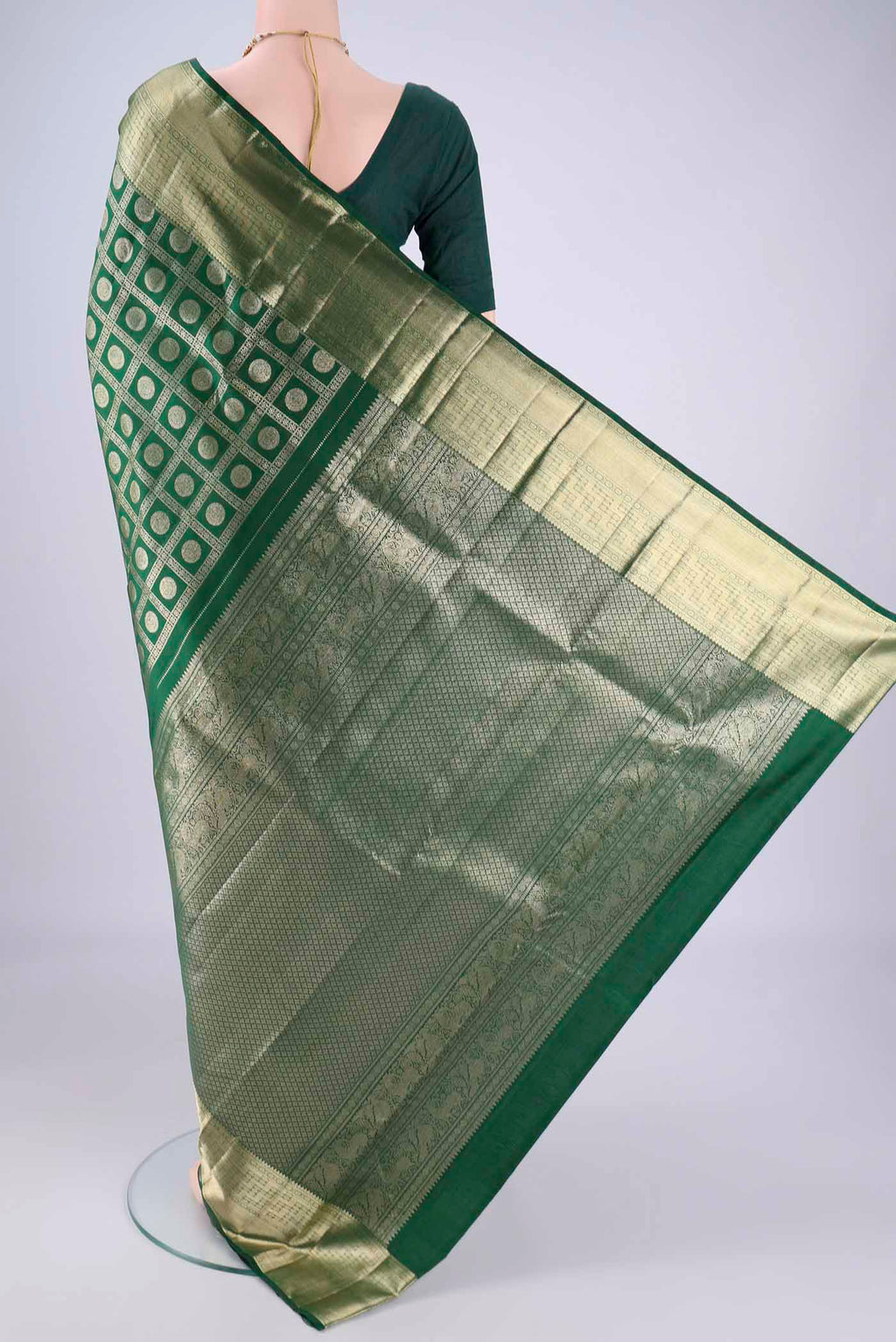 Flat view of Bottle Green Kanchipuram Silk Saree with Zari Brocade on the body and Zari Border. 