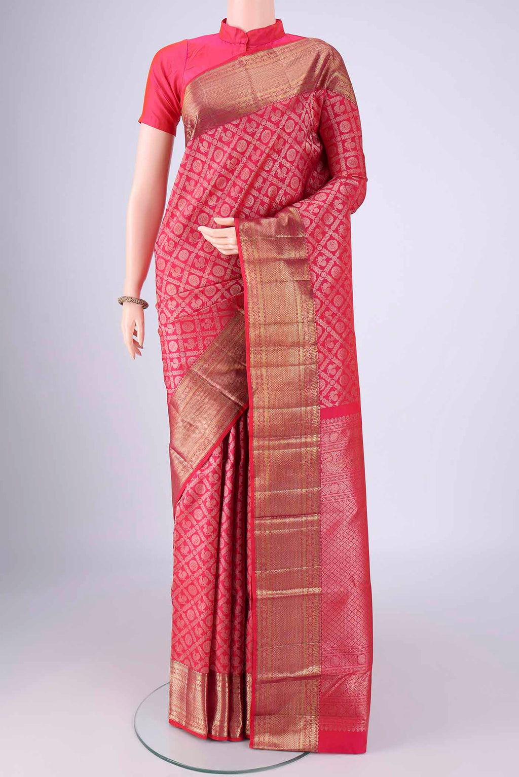 Rani Pink Kanchipuram Silk Saree with Zari Brocade on the body and Zari Border.  displayed on a mannequin
