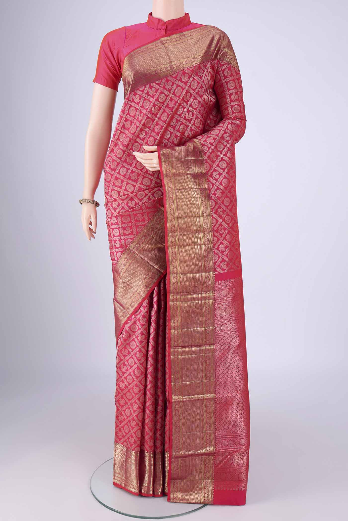 Rani Pink Kanchipuram Silk Saree with Zari Brocade on the body and Zari Border.  displayed on a mannequin