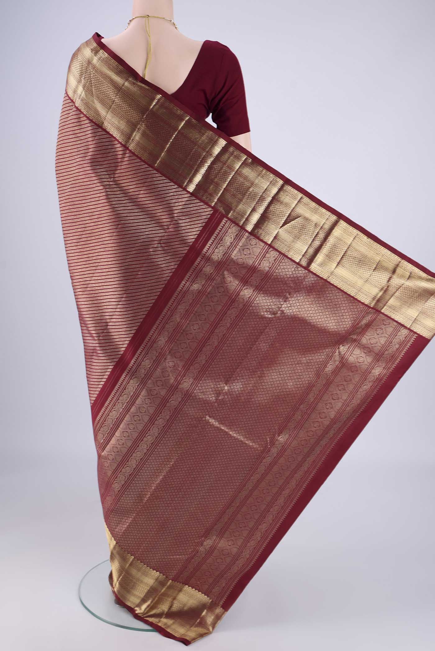 Flat view of Maroon Kanchipuram Silk Saree with Zari Brocade on the body and Zari Border. 