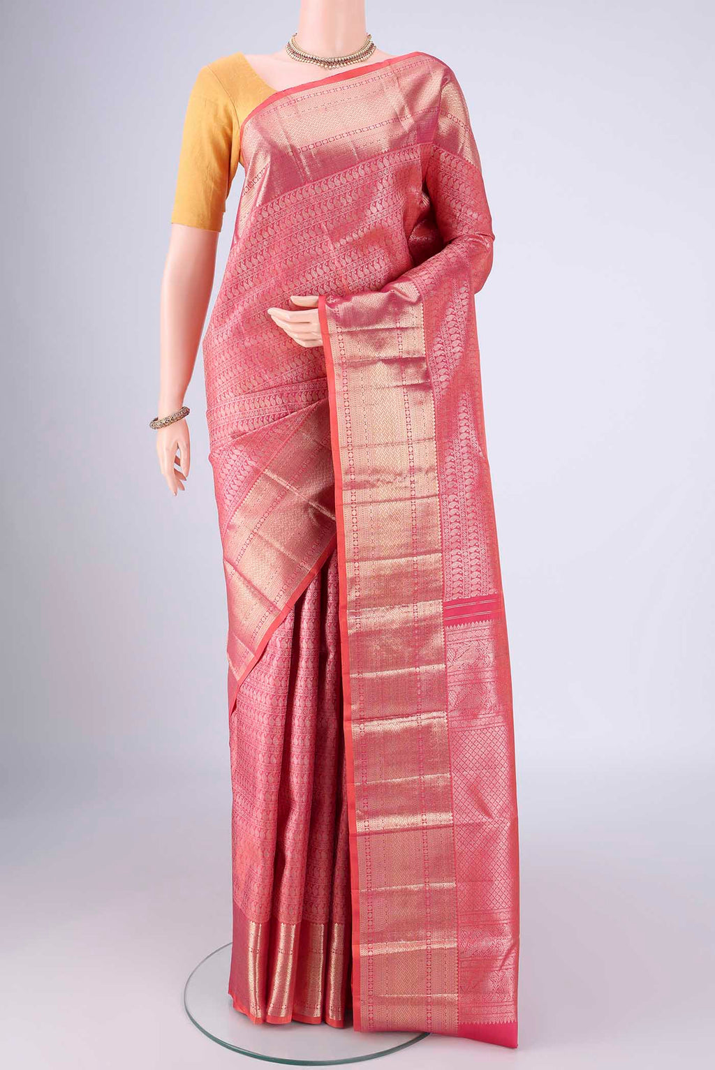Pink Kanchipuram Silk Saree with Zari Brocade on the body and Zari Border.  displayed on a mannequin