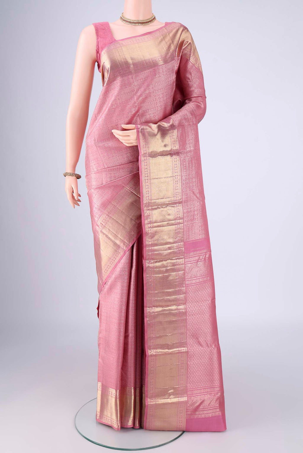 Rose pink Kanchipuram Silk Saree with Zari Brocade on the body and Zari Border.  displayed on a mannequin
