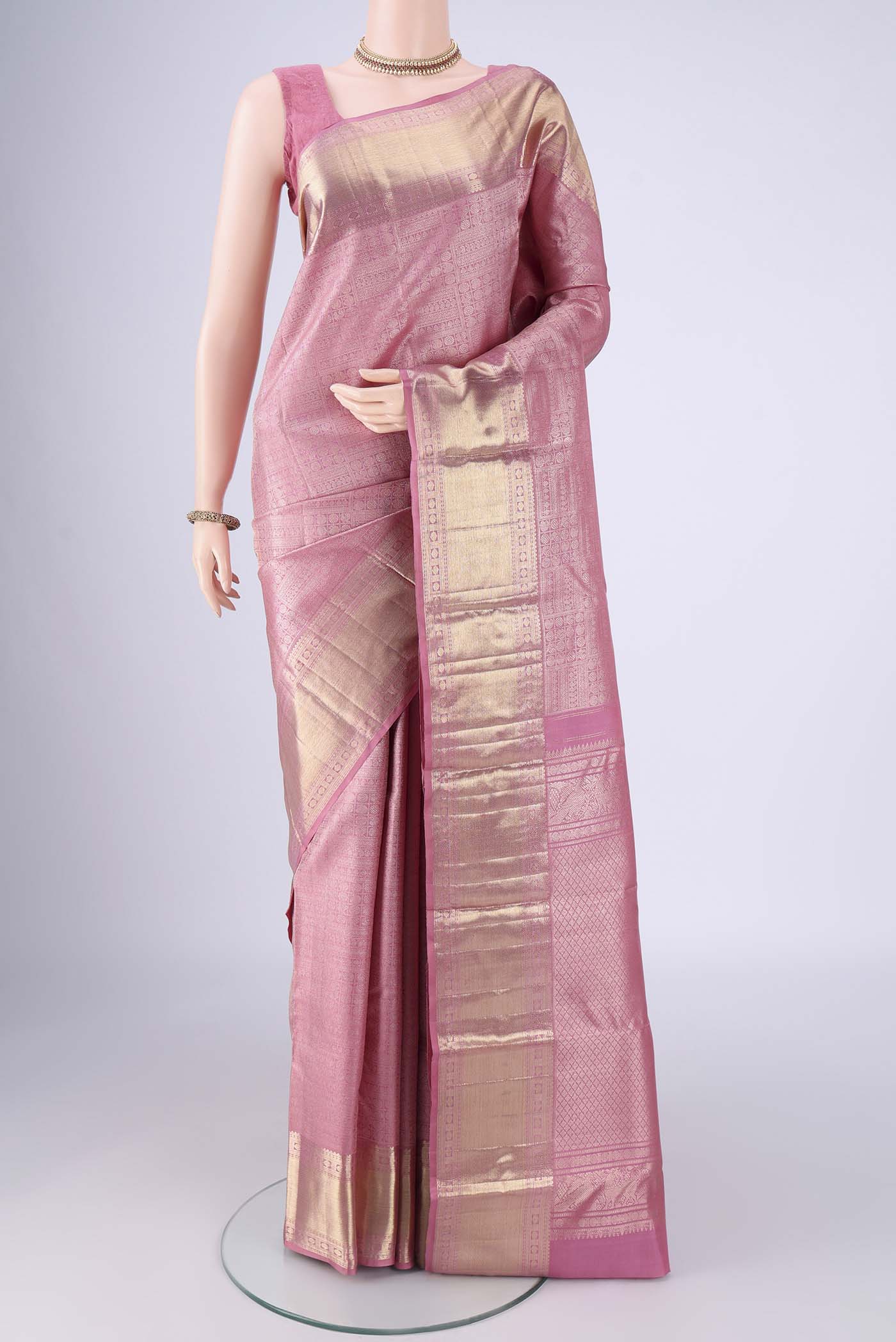 Rose pink Kanchipuram Silk Saree with Zari Brocade on the body and Zari Border.  displayed on a mannequin