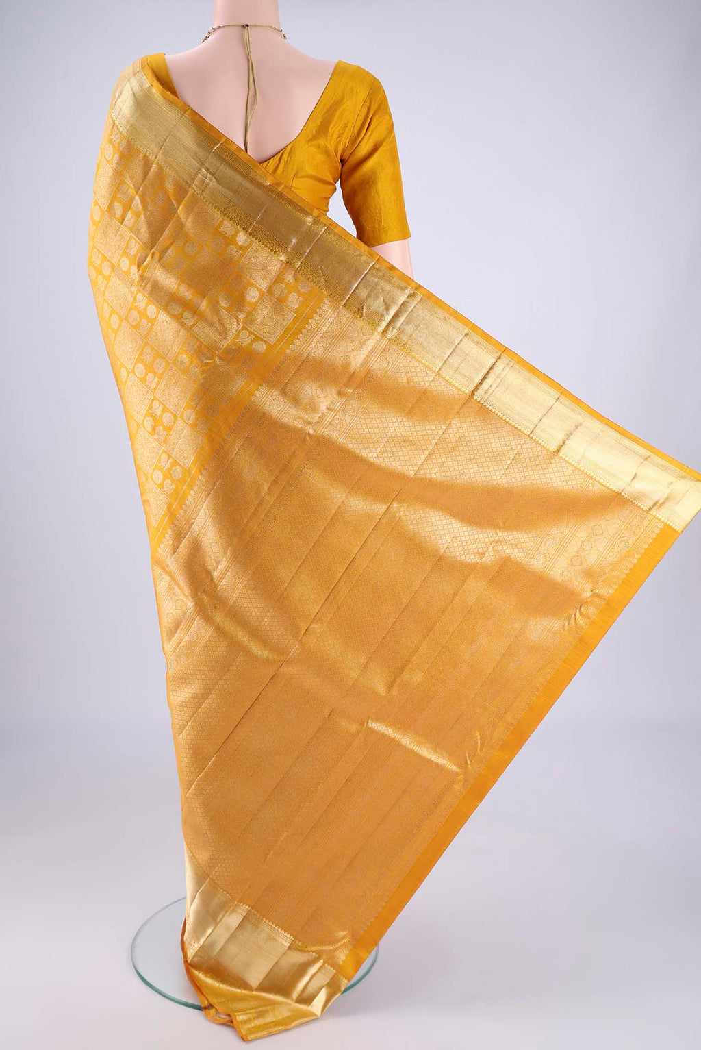 Flat view of Mustard Kanchipuram Silk Saree with Zari Brocade on the body and Zari Border. 