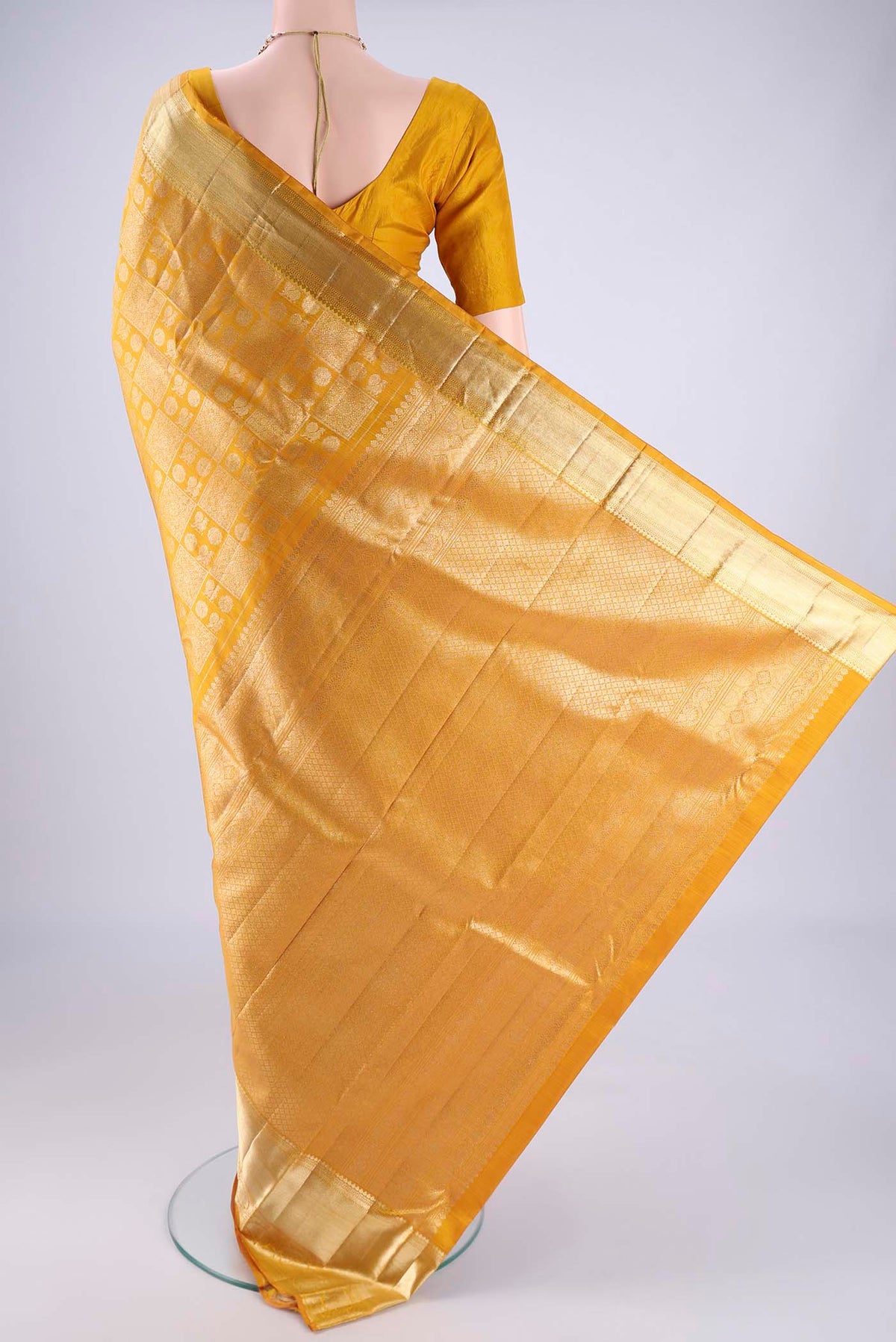 Flat view of Mustard Kanchipuram Silk Saree with Zari Brocade on the body and Zari Border. 