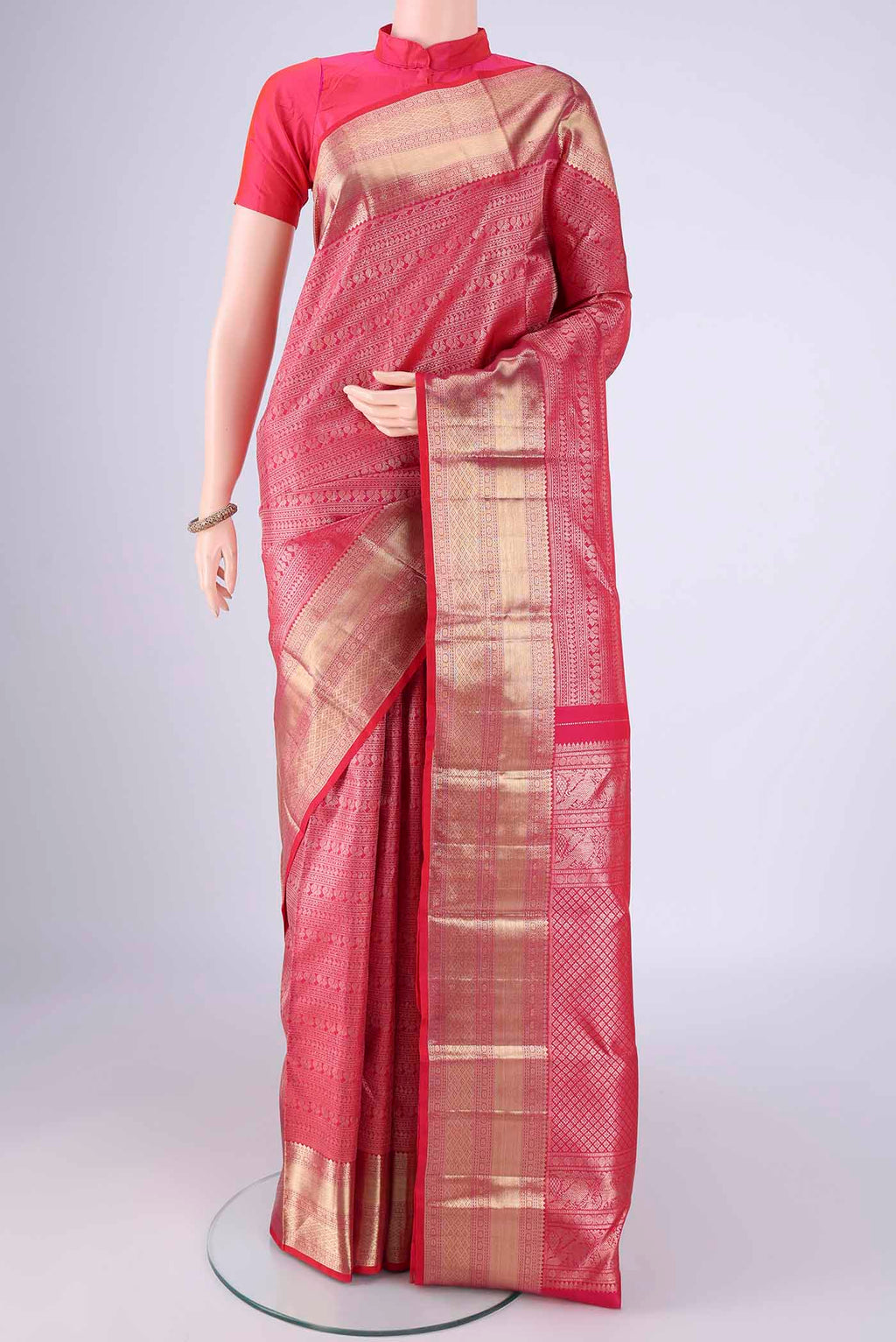 Dark Pink Kanchipuram Silk Saree with Zari Brocade on the body and Zari Border.  displayed on a mannequin