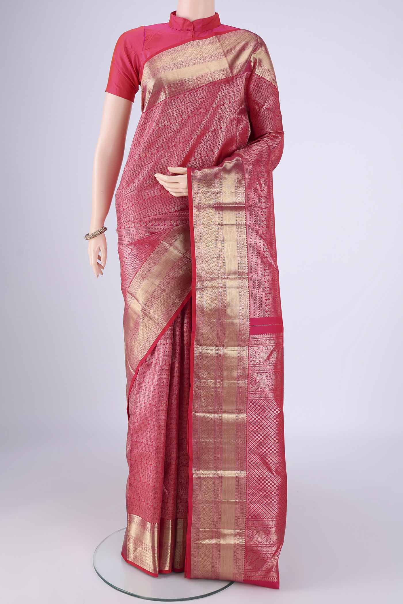 Dark Pink Kanchipuram Silk Saree with Zari Brocade on the body and Zari Border.  displayed on a mannequin