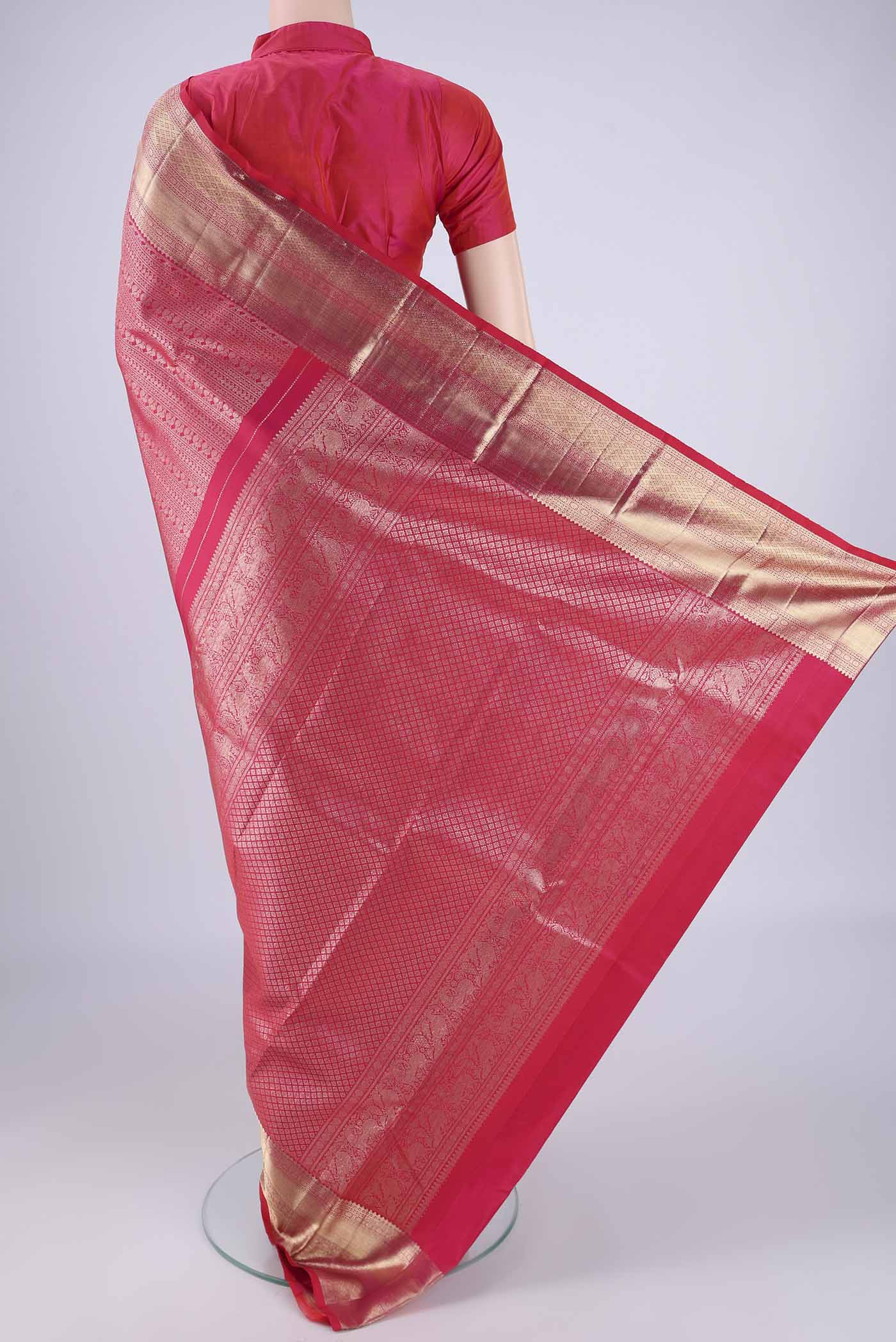 Flat view of Dark Pink Kanchipuram Silk Saree with Zari Brocade on the body and Zari Border. 