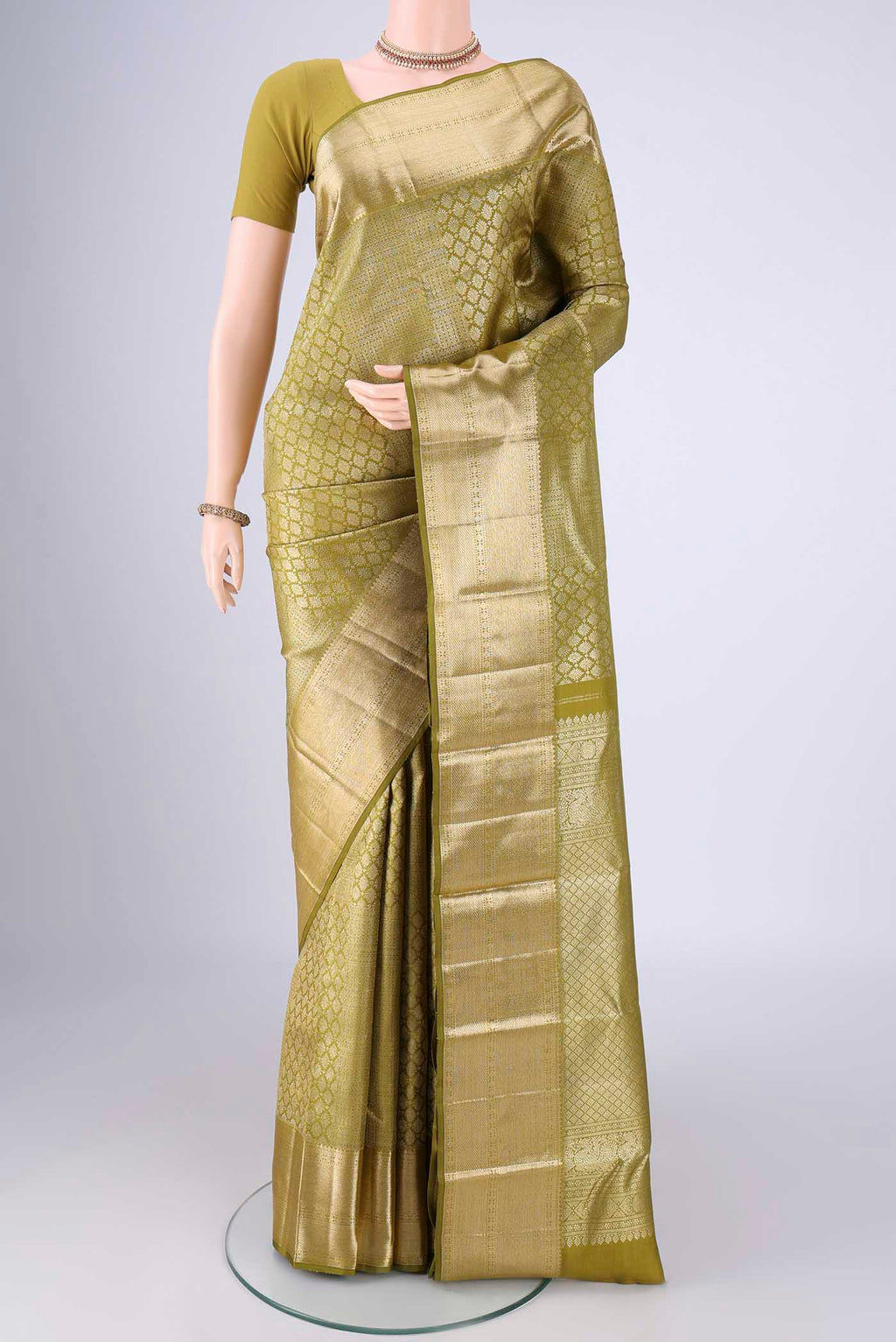 Mehandi Green Kanchipuram Silk Saree with Zari Brocade on the body and Zari Border.  displayed on a mannequin